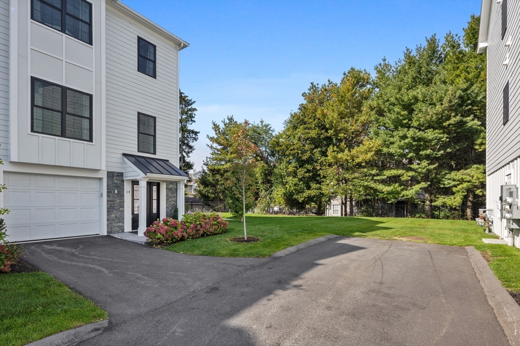 68 Prospect Street, Unit 14 Peabody, MA 01960 - Photo 27 of 29 a view of a house with a yard and large trees