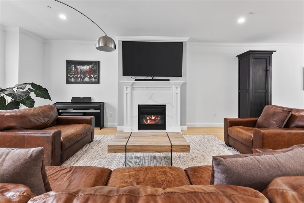 68 Prospect Street, Unit 14 Peabody, MA 01960 - Photo 7 of 29 a living room with furniture and a fireplace