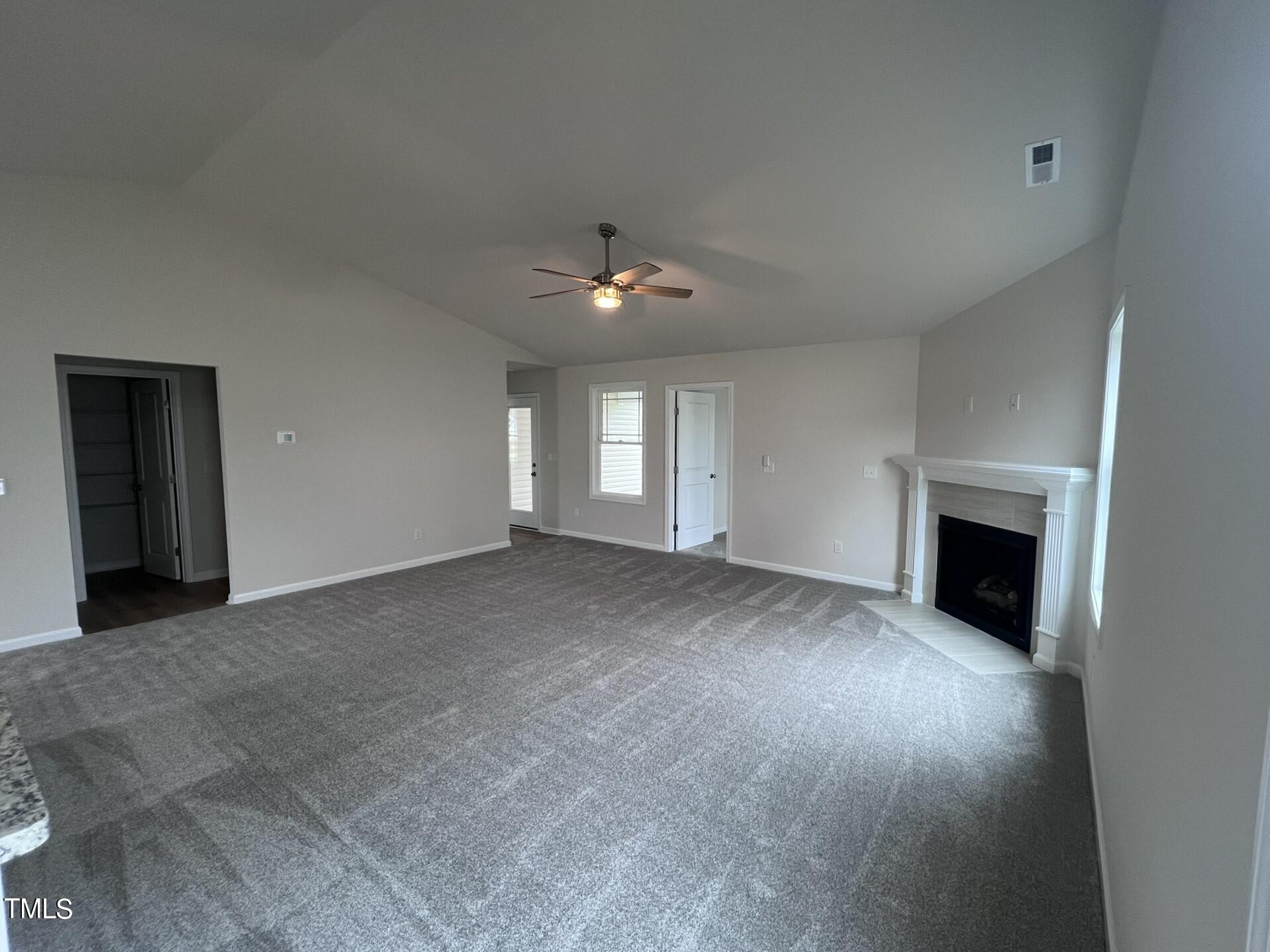 32 Scotties Ridge Drive Princeton, NC 27569 - Photo 13 of 24 an empty room with windows and fireplace