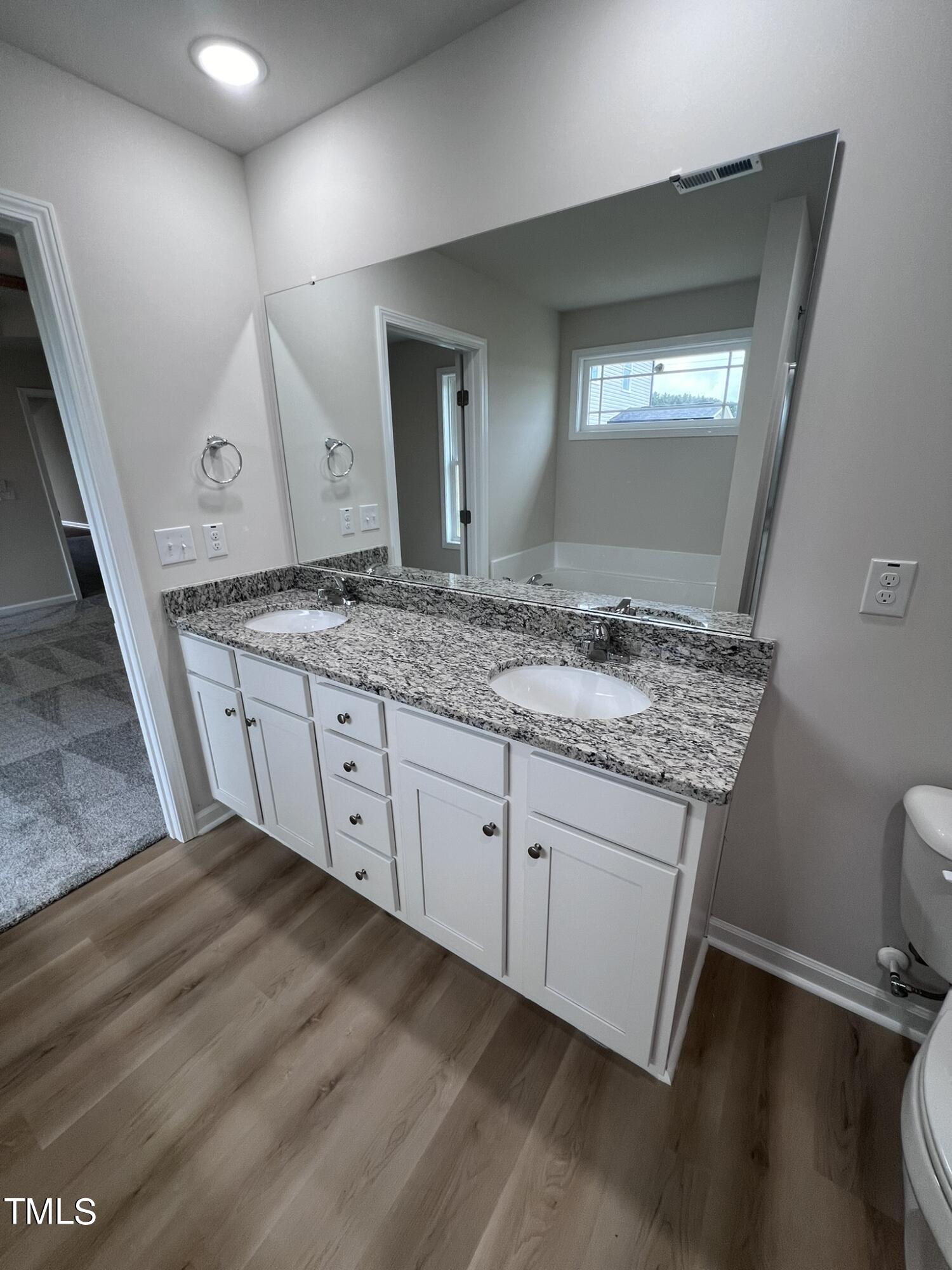 32 Scotties Ridge Drive Princeton, NC 27569 - Photo 17 of 24 a spacious bathroom with a granite countertop sink and a mirror