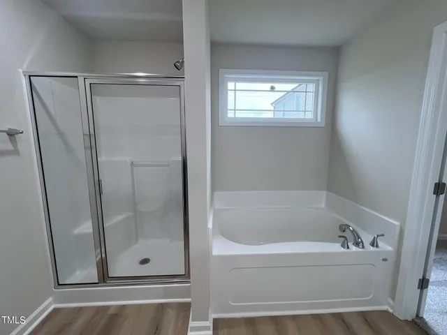 a bathroom with a bathtub and shower