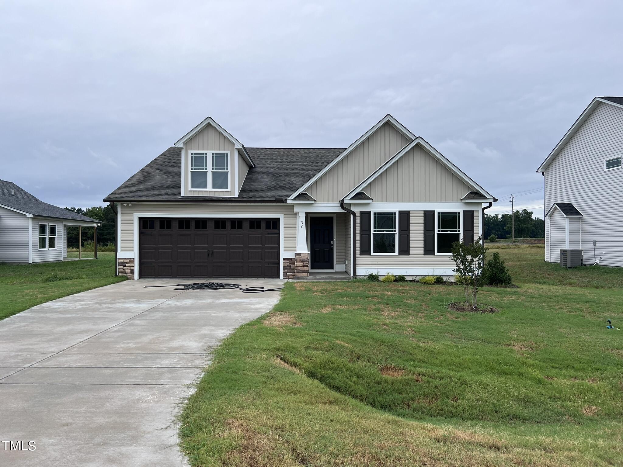 32 Scotties Ridge Drive Princeton, NC 27569 - Photo 2 of 24 a front view of a house with a garden