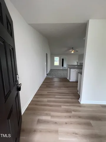 a view of a kitchen from the hallway