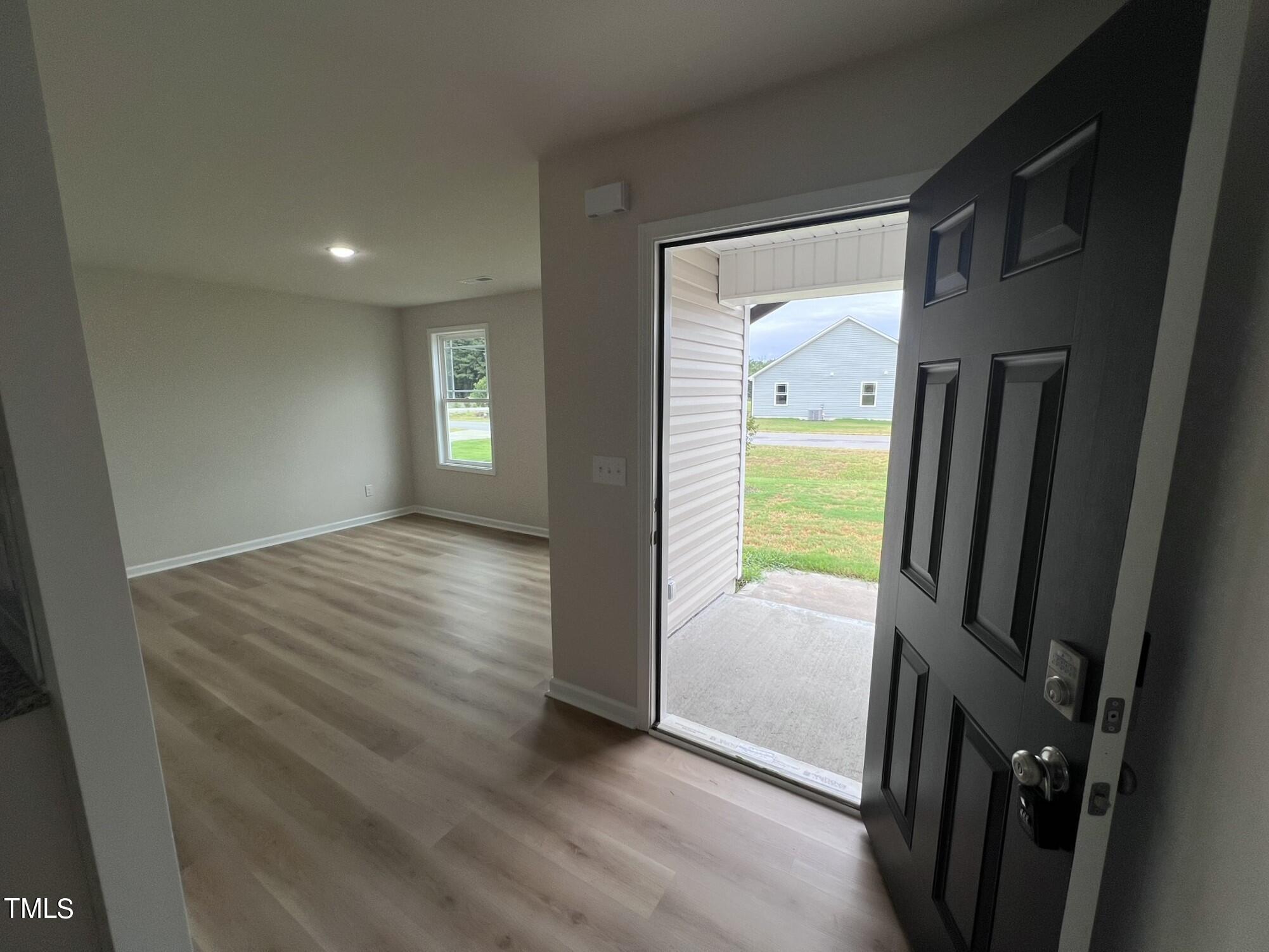32 Scotties Ridge Drive Princeton, NC 27569 - Photo 5 of 24 wooden floor in an empty room with a window