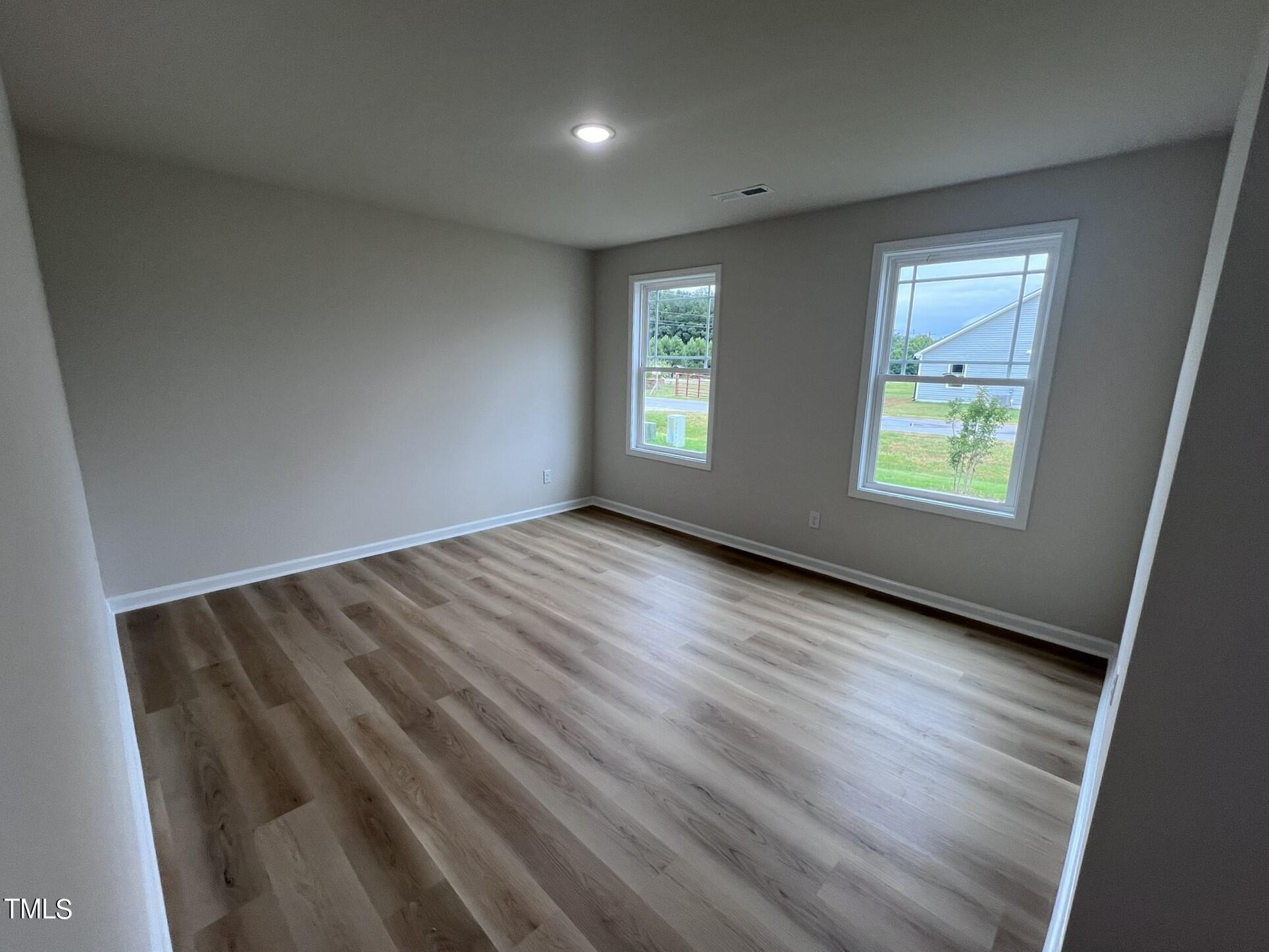 32 Scotties Ridge Drive Princeton, NC 27569 - Photo 6 of 24 wooden floor in an empty room with a window