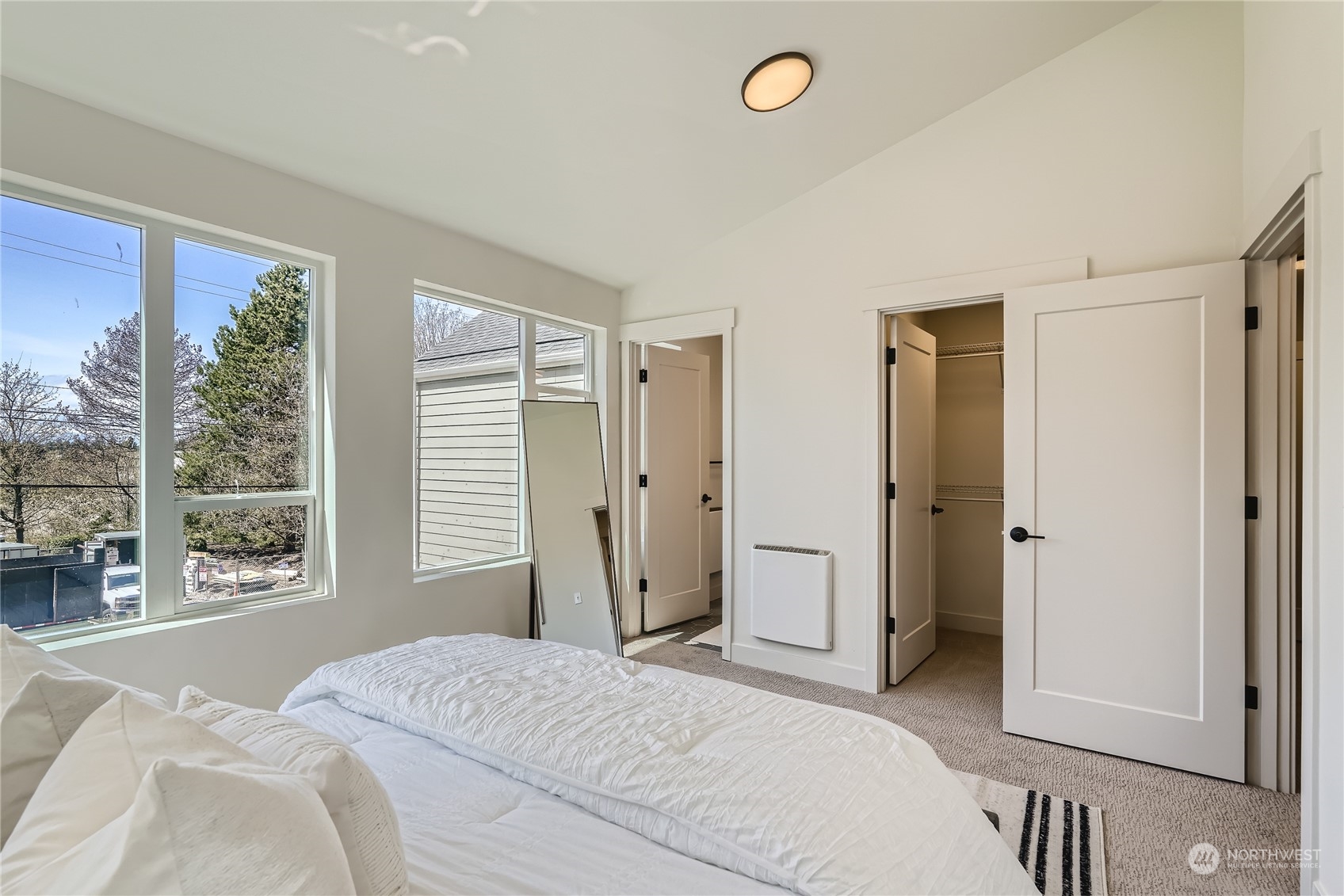 9524 3rd Avenue Northeast, Unit B Seattle, WA 98115 - Photo 11 of 21 a bedroom with a bed and a large window