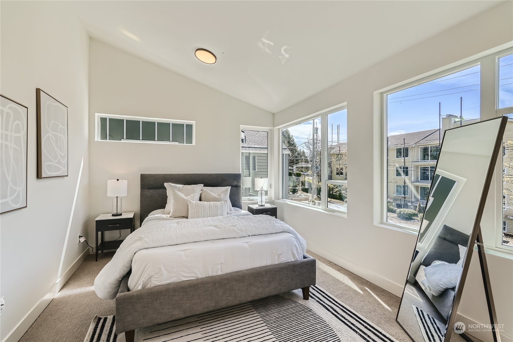 9524 3rd Avenue Northeast, Unit B Seattle, WA 98115 - Photo 8 of 21 a bedroom with a bed wooden floor and a large window