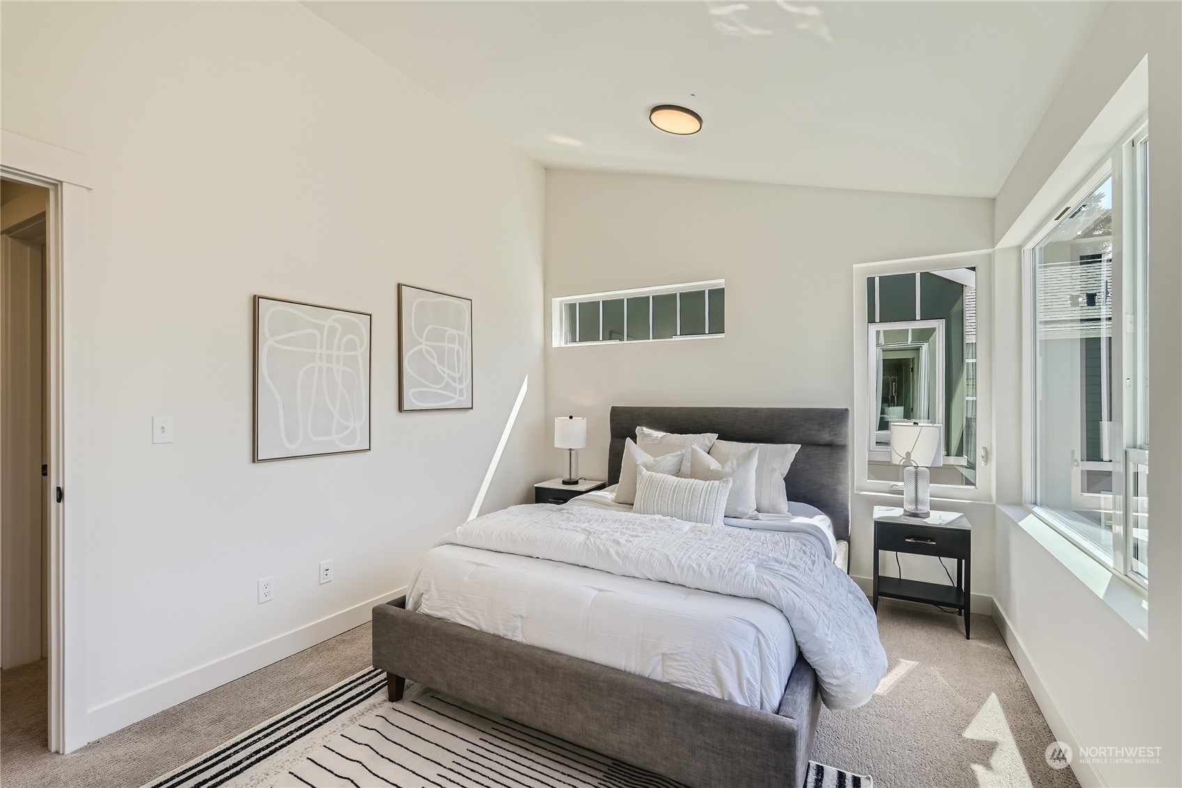 9524 3rd Avenue Northeast, Unit B Seattle, WA 98115 - Photo 9 of 21 a bedroom with a bed and glass door