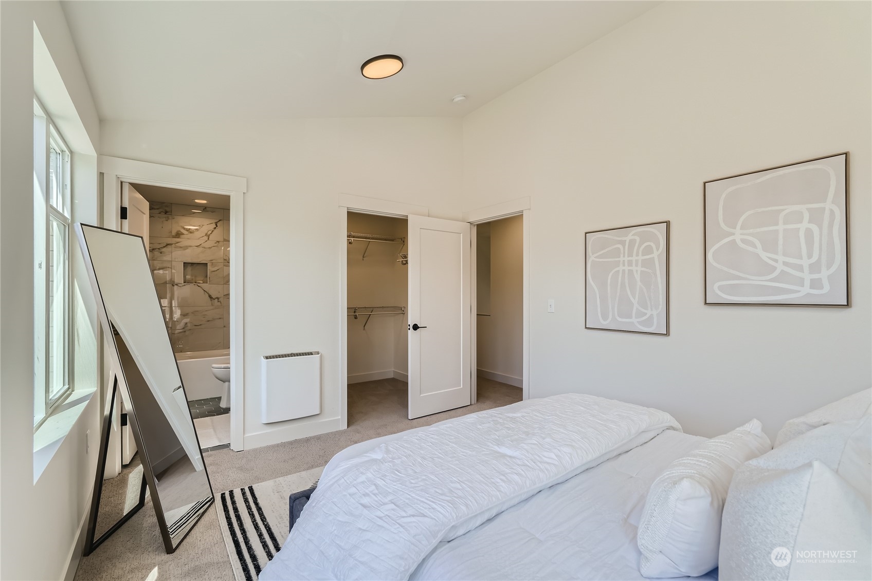 9524 3rd Avenue Northeast, Unit B Seattle, WA 98115 - Photo 10 of 21 a bedroom with a bed and a view of bathroom