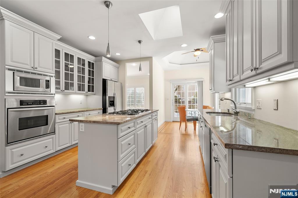 137 6th Street Cresskill, NJ 07626 - Photo 12 of 35 a kitchen with stainless steel appliances granite countertop a stove and cabinets