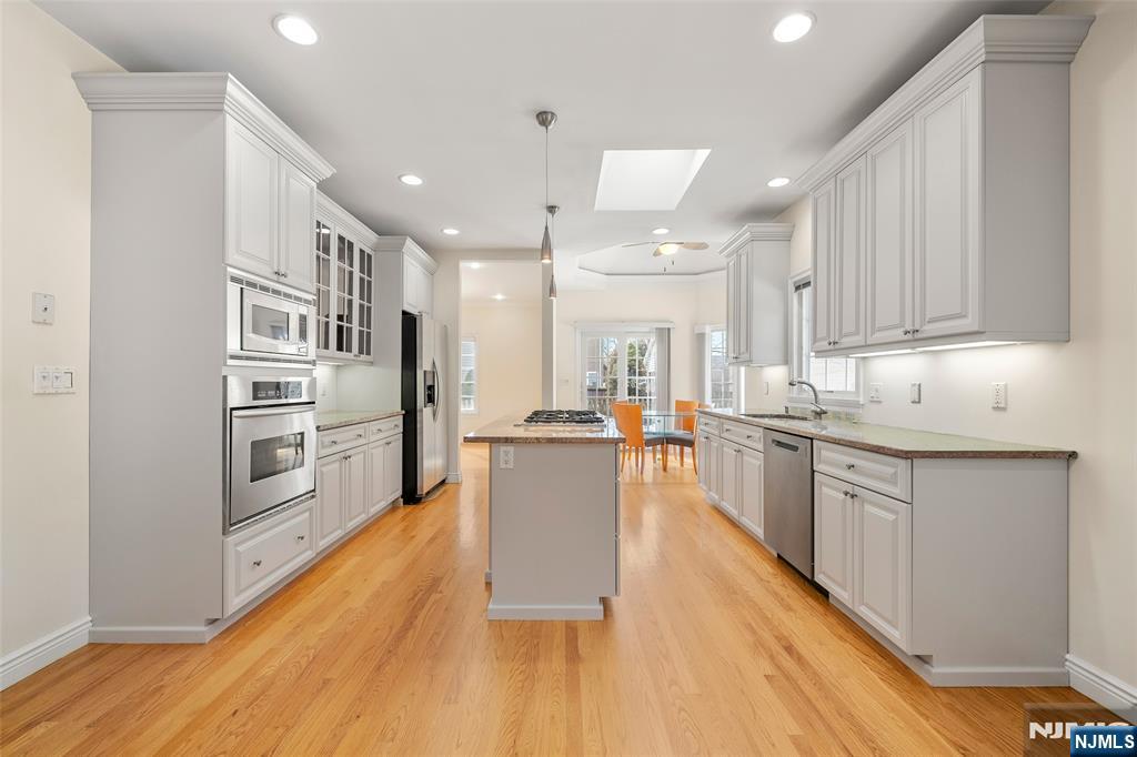 137 6th Street Cresskill, NJ 07626 - Photo 13 of 35 a kitchen with kitchen island a counter top space a sink stainless steel appliances and cabinets