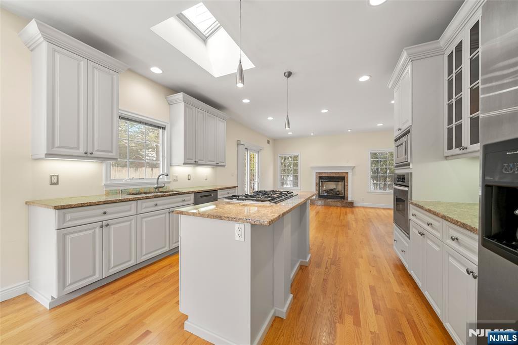 137 6th Street Cresskill, NJ 07626 - Photo 14 of 35 a large kitchen with stainless steel appliances granite countertop a lot of counter space and wooden floor