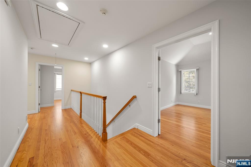 137 6th Street Cresskill, NJ 07626 - Photo 16 of 35 a view of hallway with stairs and wooden floor