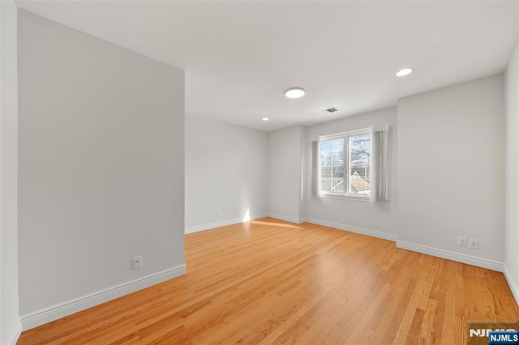 137 6th Street Cresskill, NJ 07626 - Photo 22 of 35 a view of an empty room with wooden floor and a window