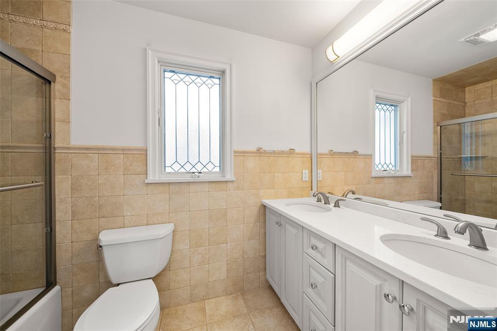 137 6th Street Cresskill, NJ 07626 - Photo 26 of 35 a bathroom with a toilet sink and mirror