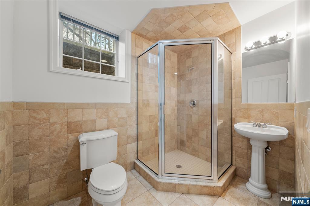 137 6th Street Cresskill, NJ 07626 - Photo 31 of 35 a bathroom with a shower a toilet and a sink
