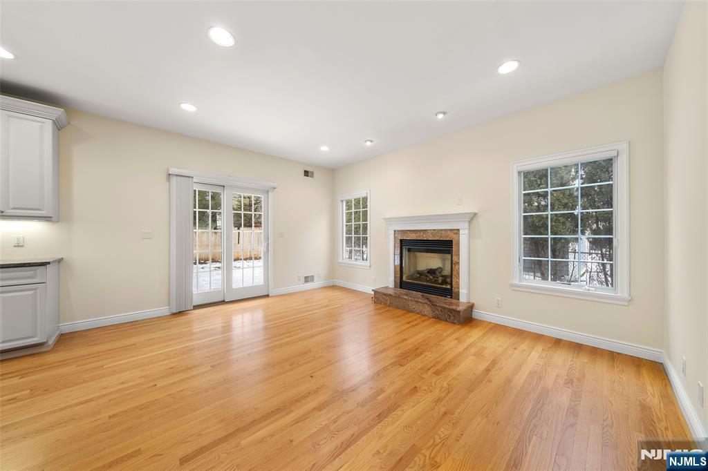 137 6th Street Cresskill, NJ 07626 - Photo 7 of 35 an empty room with wooden floor and a fireplace