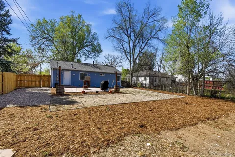 a view of a backyard with a tree