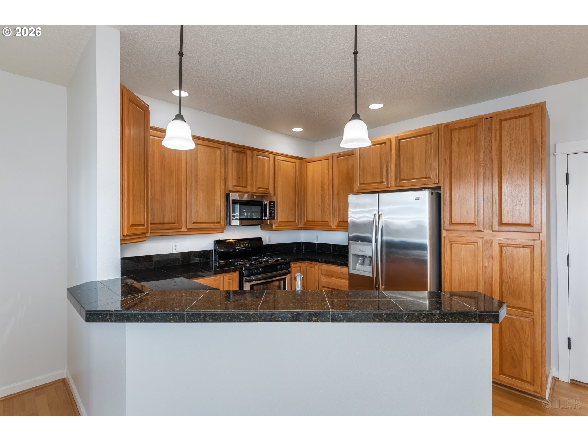 9161 Northwest Germantown Road Portland, OR 97231 - Photo 9 of 28 a kitchen with kitchen island a counter top space appliances and cabinets