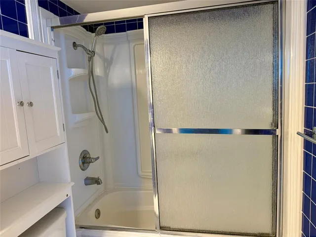 a bathroom with a glass shower door