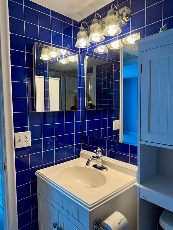 101 Briny Avenue, Unit 1606 Pompano Beach, FL 33062 - Photo 12 of 25 a bathroom with a sink and mirror