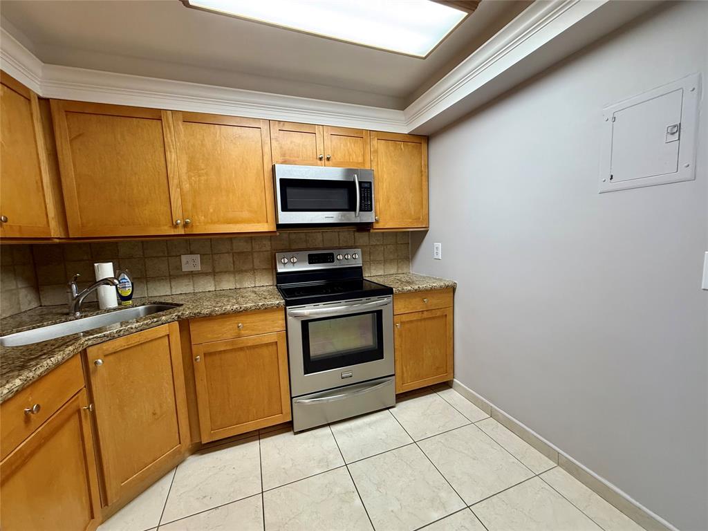 101 Briny Avenue, Unit 1606 Pompano Beach, FL 33062 - Photo 2 of 25 a kitchen with stainless steel appliances granite countertop a stove microwave and sink