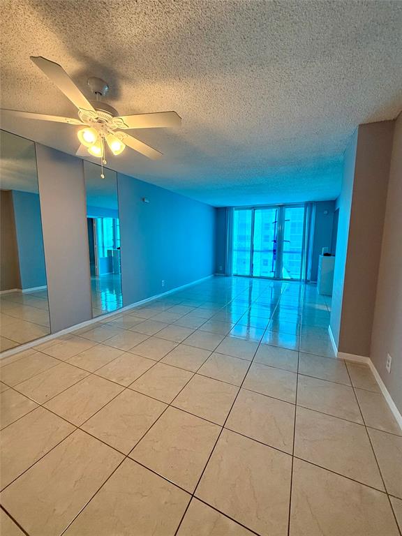 101 Briny Avenue, Unit 1606 Pompano Beach, FL 33062 - Photo 5 of 25 a view of an empty room with window and chandelier fan