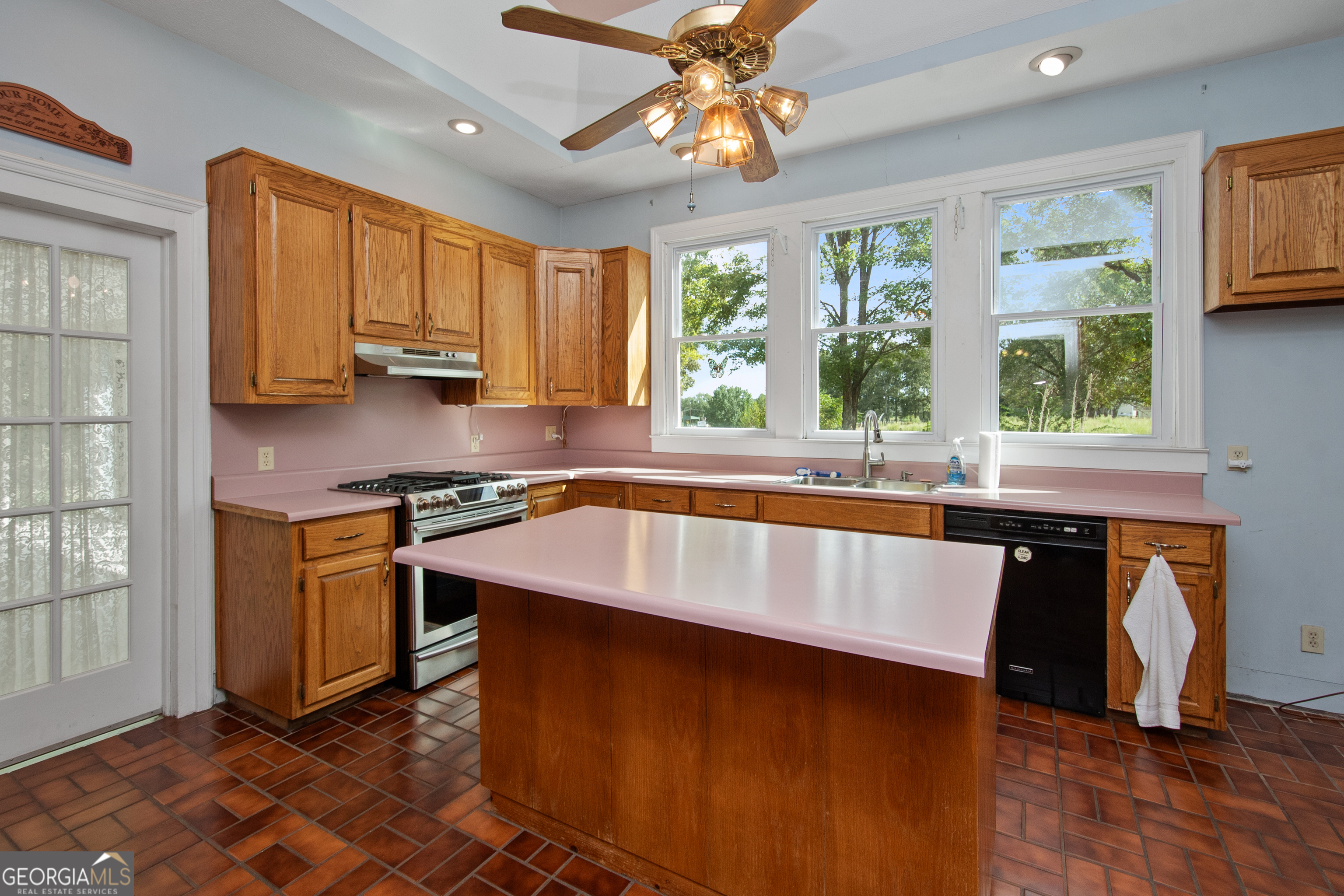 402 Tom Bell Road Milner, GA 30257 - Photo 11 of 64 a kitchen with stainless steel appliances granite countertop a sink a stove a refrigerator cabinets and a window