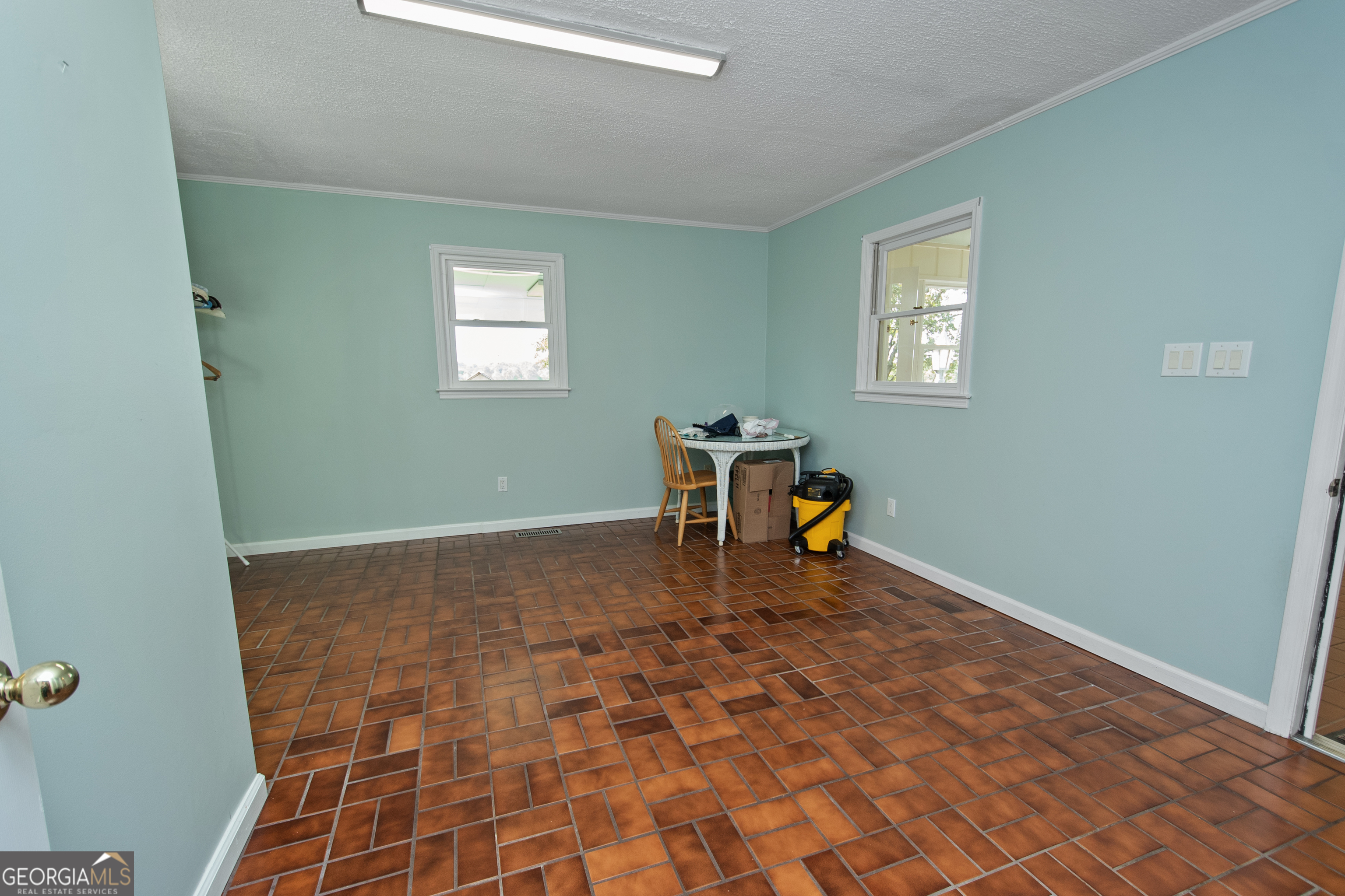 402 Tom Bell Road Milner, GA 30257 - Photo 15 of 64 a view of a workspace with wooden floor and a window