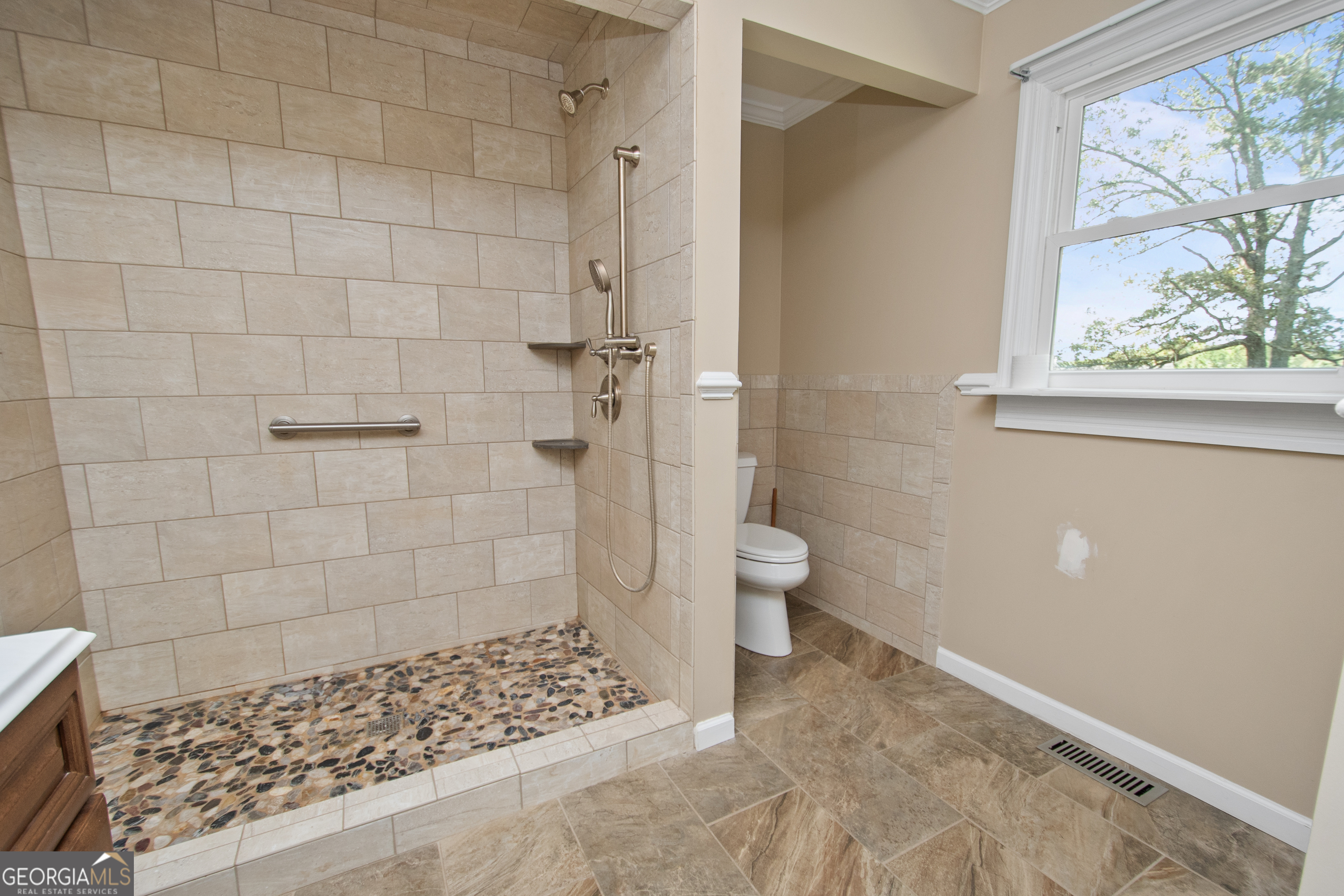 402 Tom Bell Road Milner, GA 30257 - Photo 21 of 64 a bathroom with a toilet and a shower