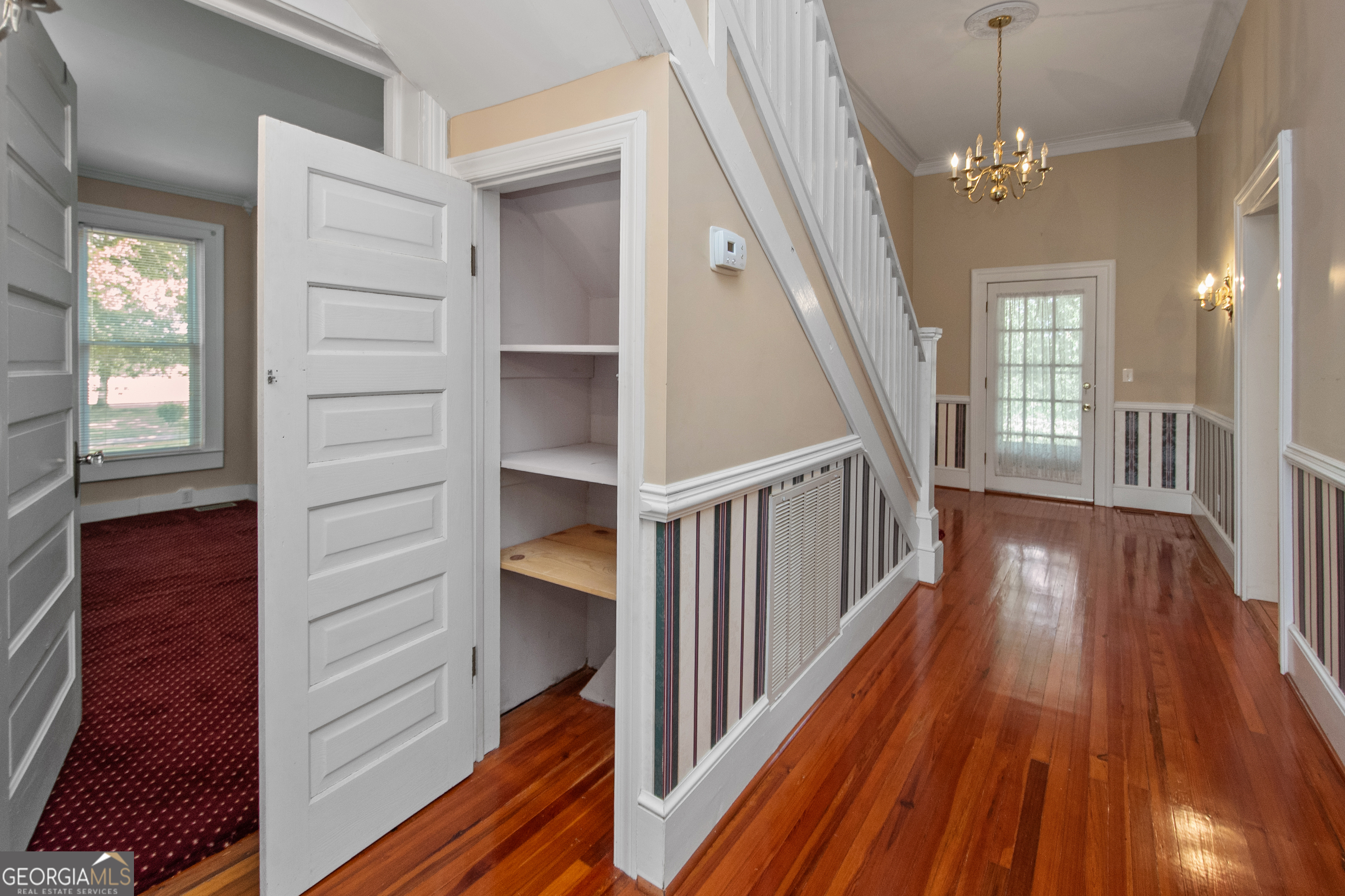 402 Tom Bell Road Milner, GA 30257 - Photo 25 of 64 a view of a hallway with wooden floor and staircase