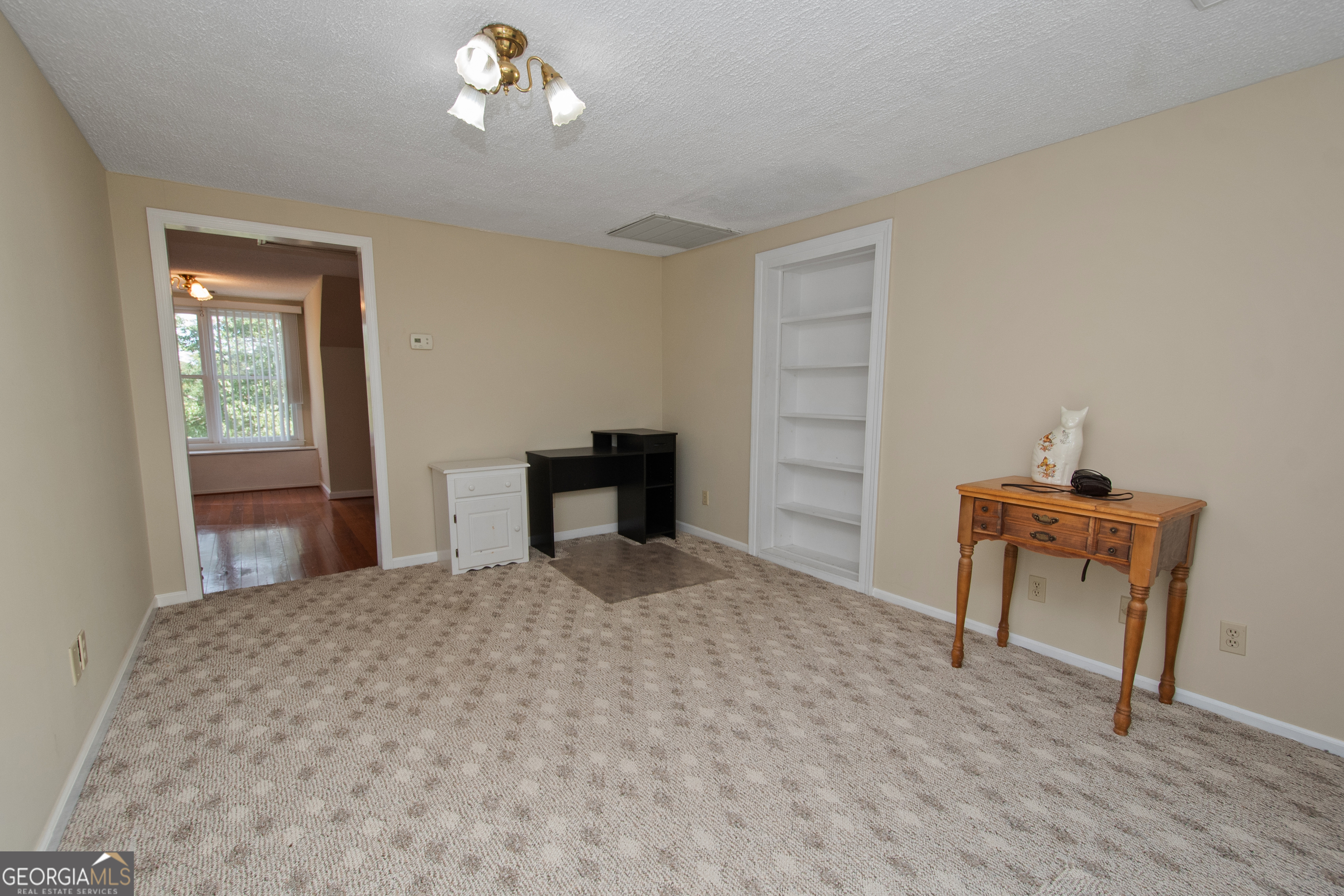 402 Tom Bell Road Milner, GA 30257 - Photo 26 of 64 a bedroom with a bed and a table