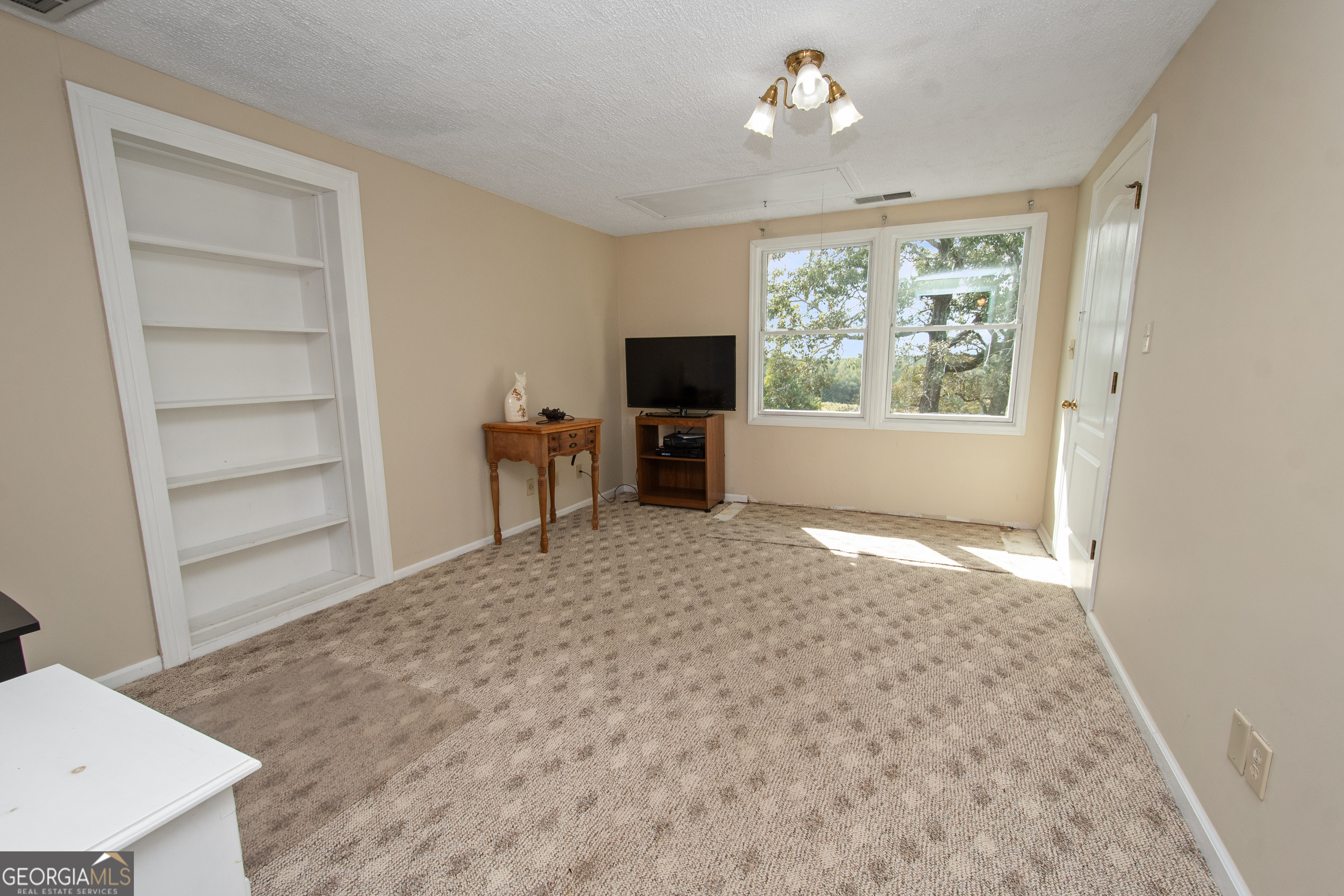 402 Tom Bell Road Milner, GA 30257 - Photo 27 of 64 a living room with furniture and a flat screen tv