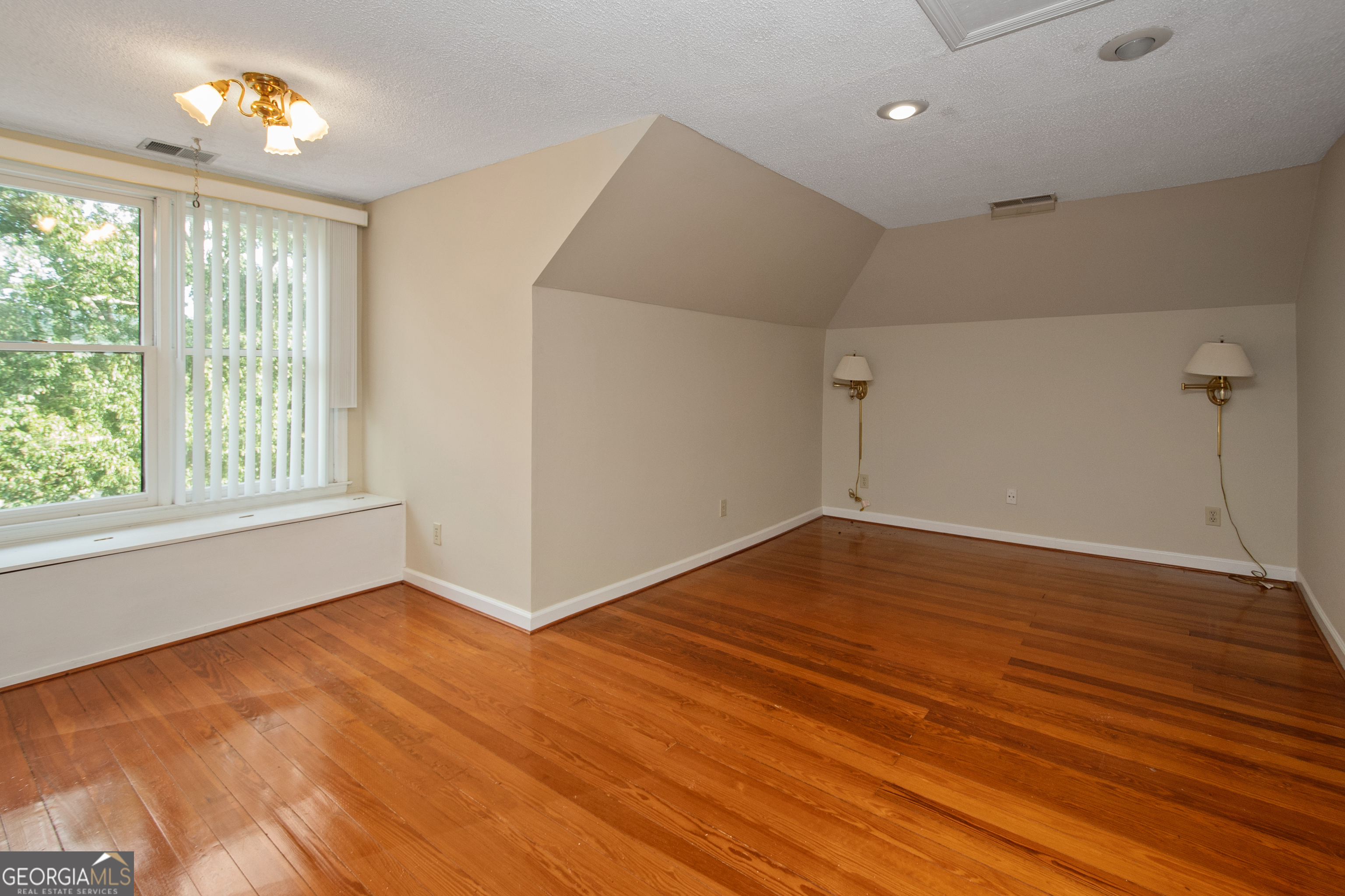 402 Tom Bell Road Milner, GA 30257 - Photo 28 of 64 wooden floor in an empty room with a window