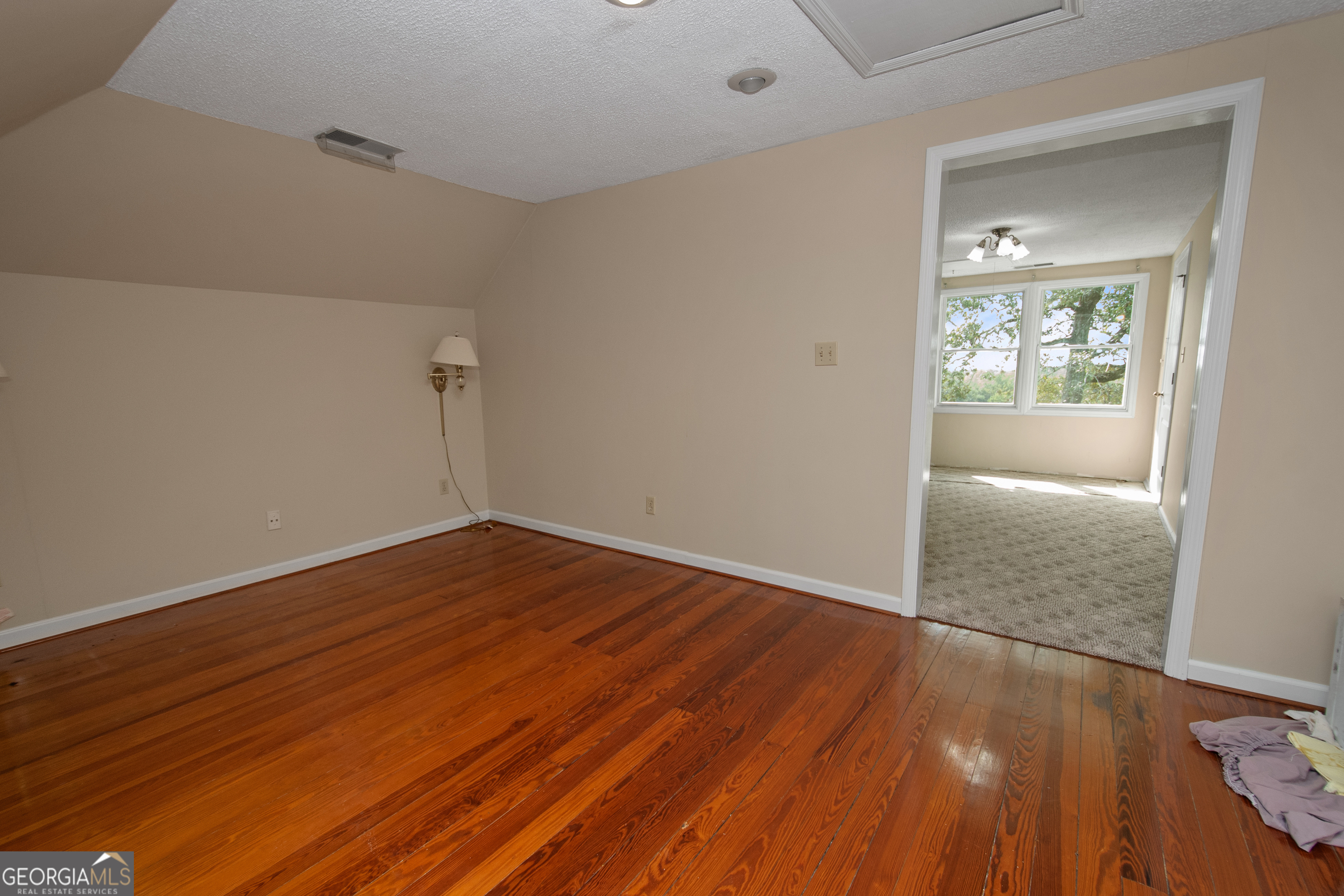 402 Tom Bell Road Milner, GA 30257 - Photo 29 of 64 wooden floor in an empty room