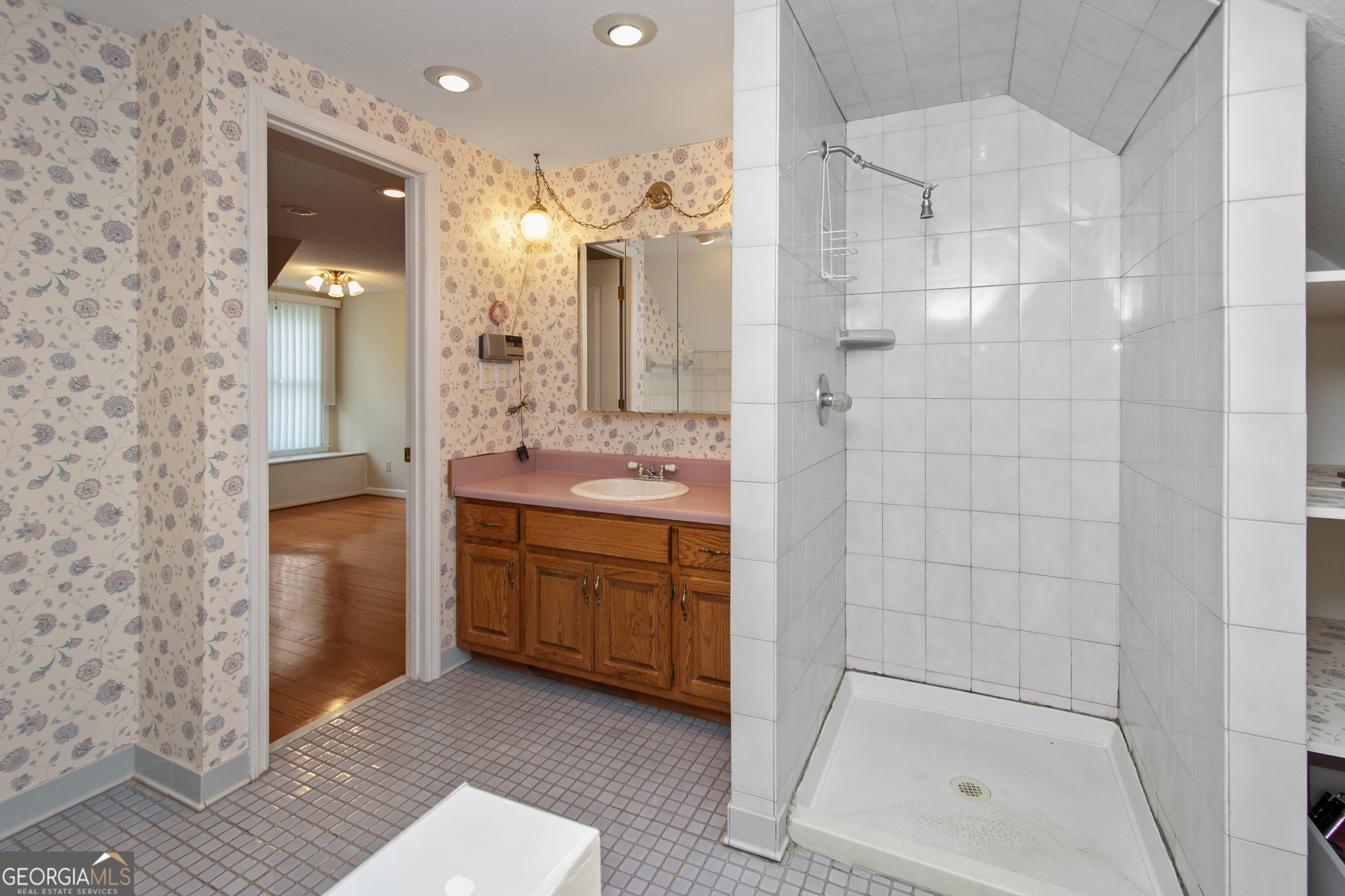 402 Tom Bell Road Milner, GA 30257 - Photo 31 of 64 a bathroom with a granite countertop sink a mirror and a shower