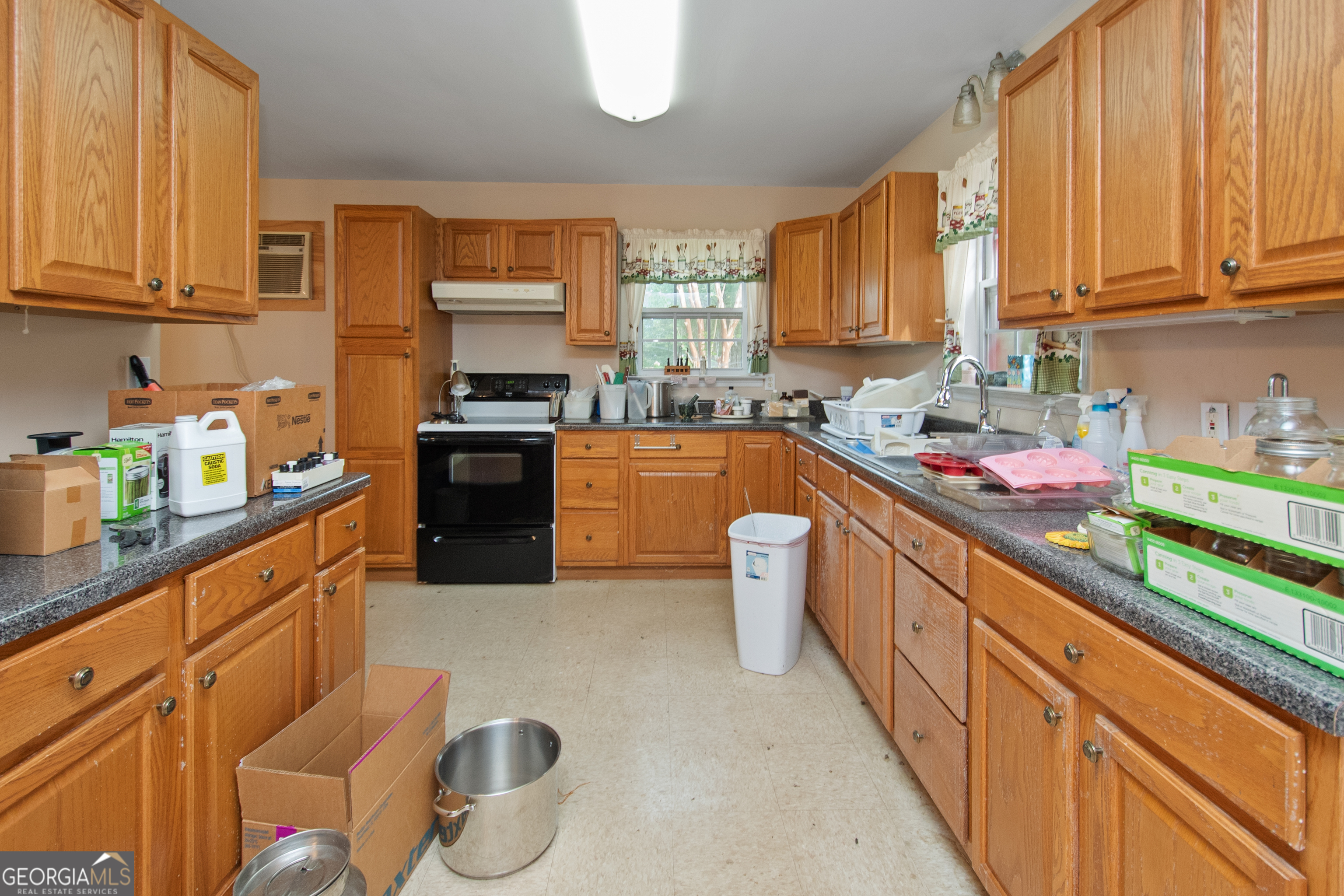 402 Tom Bell Road Milner, GA 30257 - Photo 41 of 64 a kitchen with stainless steel appliances granite countertop a stove sink and cabinets