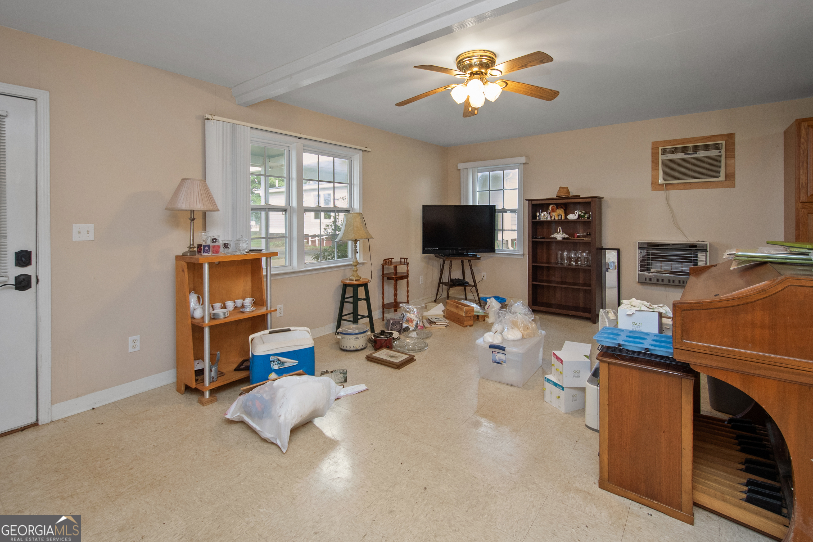 402 Tom Bell Road Milner, GA 30257 - Photo 43 of 64 a view of a workspace with furniture and a window
