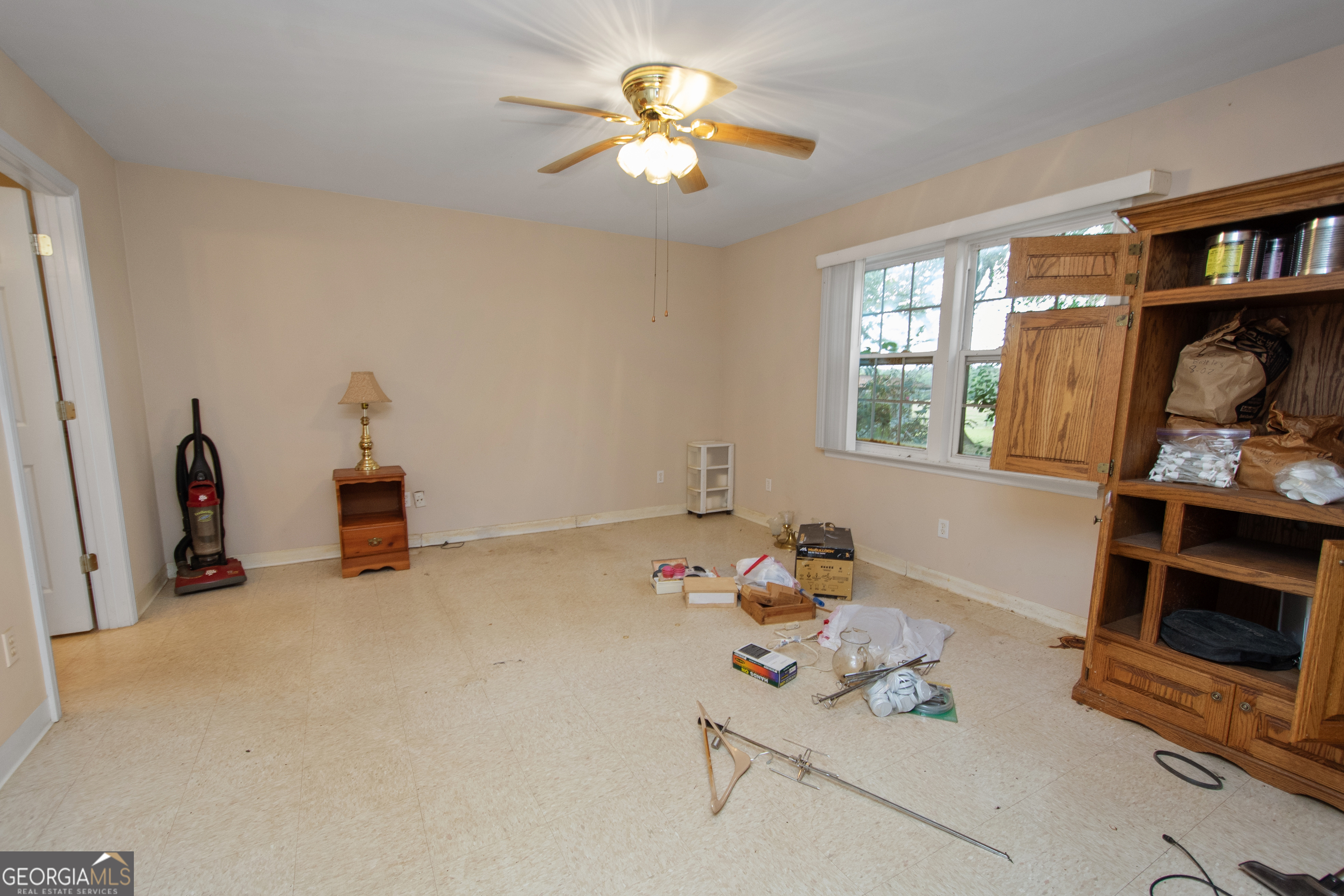 402 Tom Bell Road Milner, GA 30257 - Photo 44 of 64 a living room with furniture and a window
