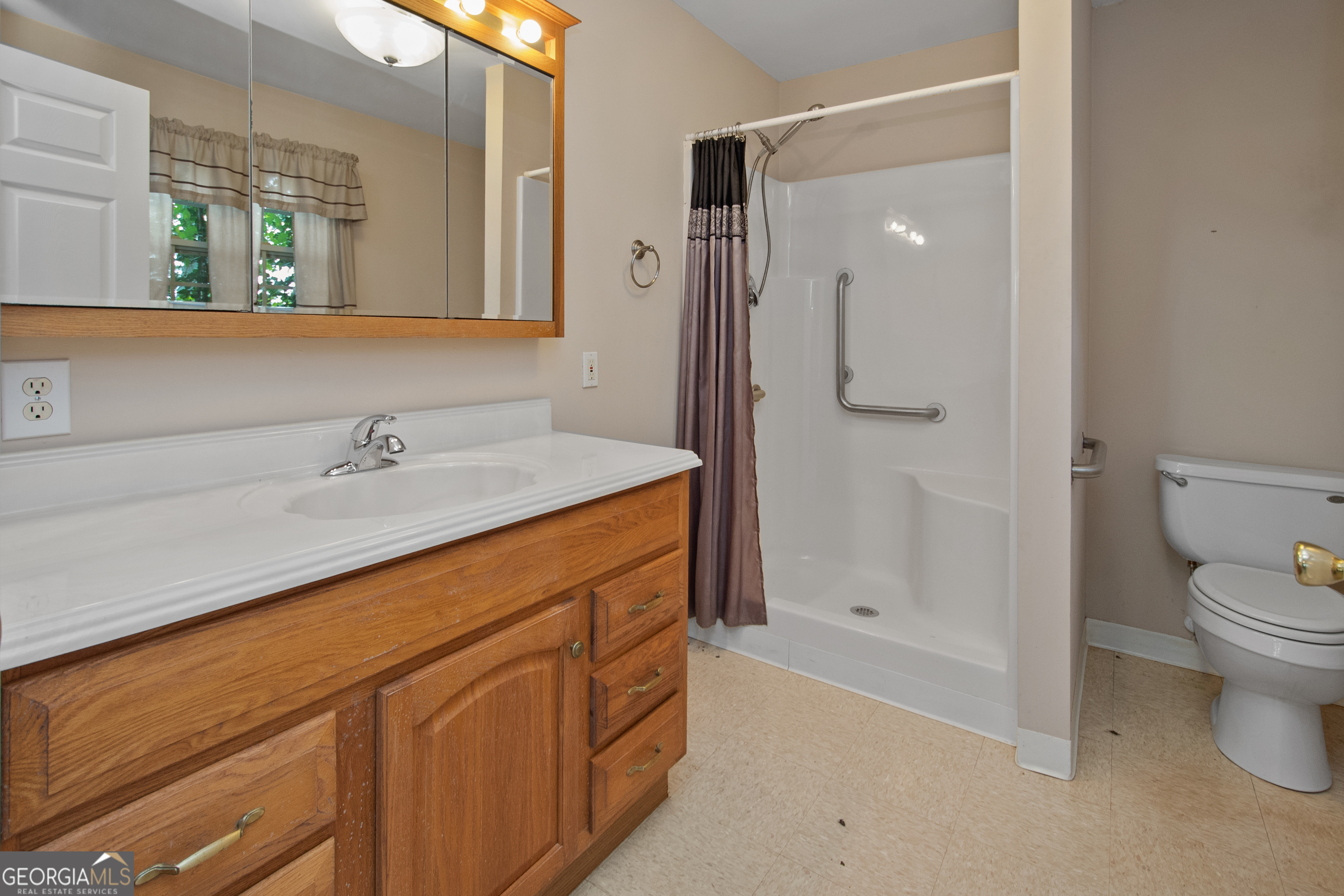402 Tom Bell Road Milner, GA 30257 - Photo 46 of 64 a bathroom with a sink a toilet and shower