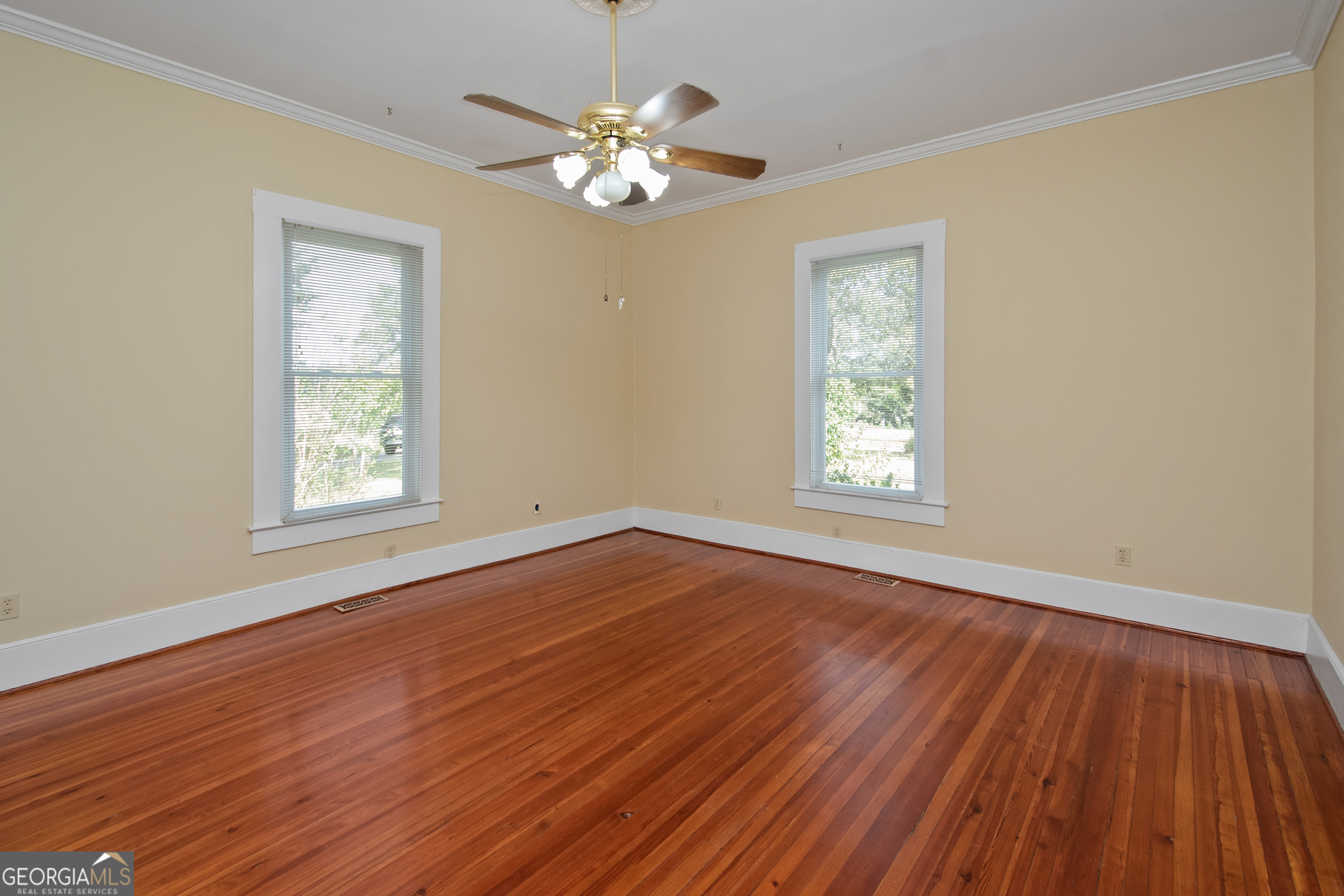 402 Tom Bell Road Milner, GA 30257 - Photo 5 of 64 a view of an empty room with wooden floor and a window