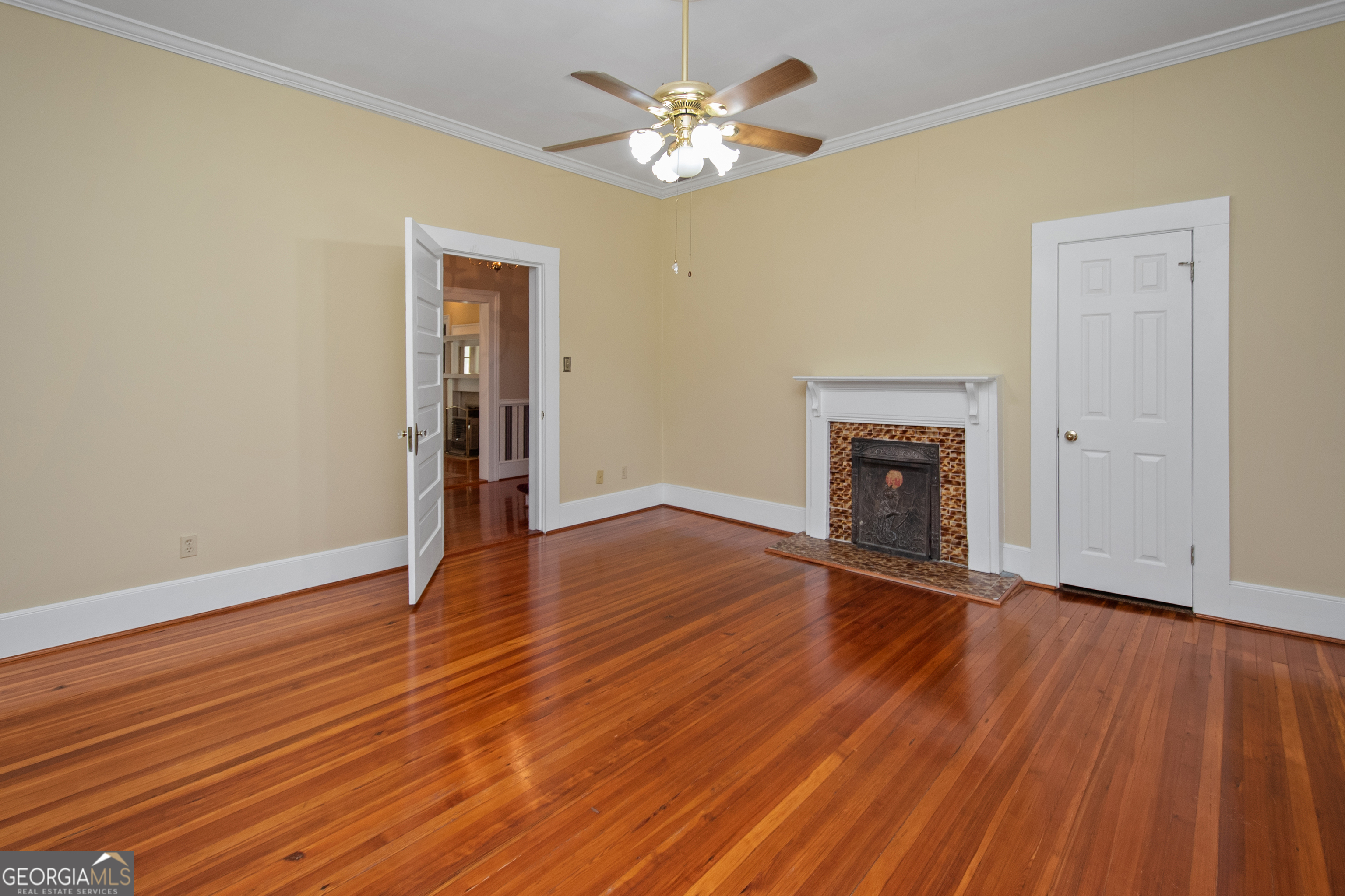 402 Tom Bell Road Milner, GA 30257 - Photo 6 of 64 a view of empty room with wooden floor and fan