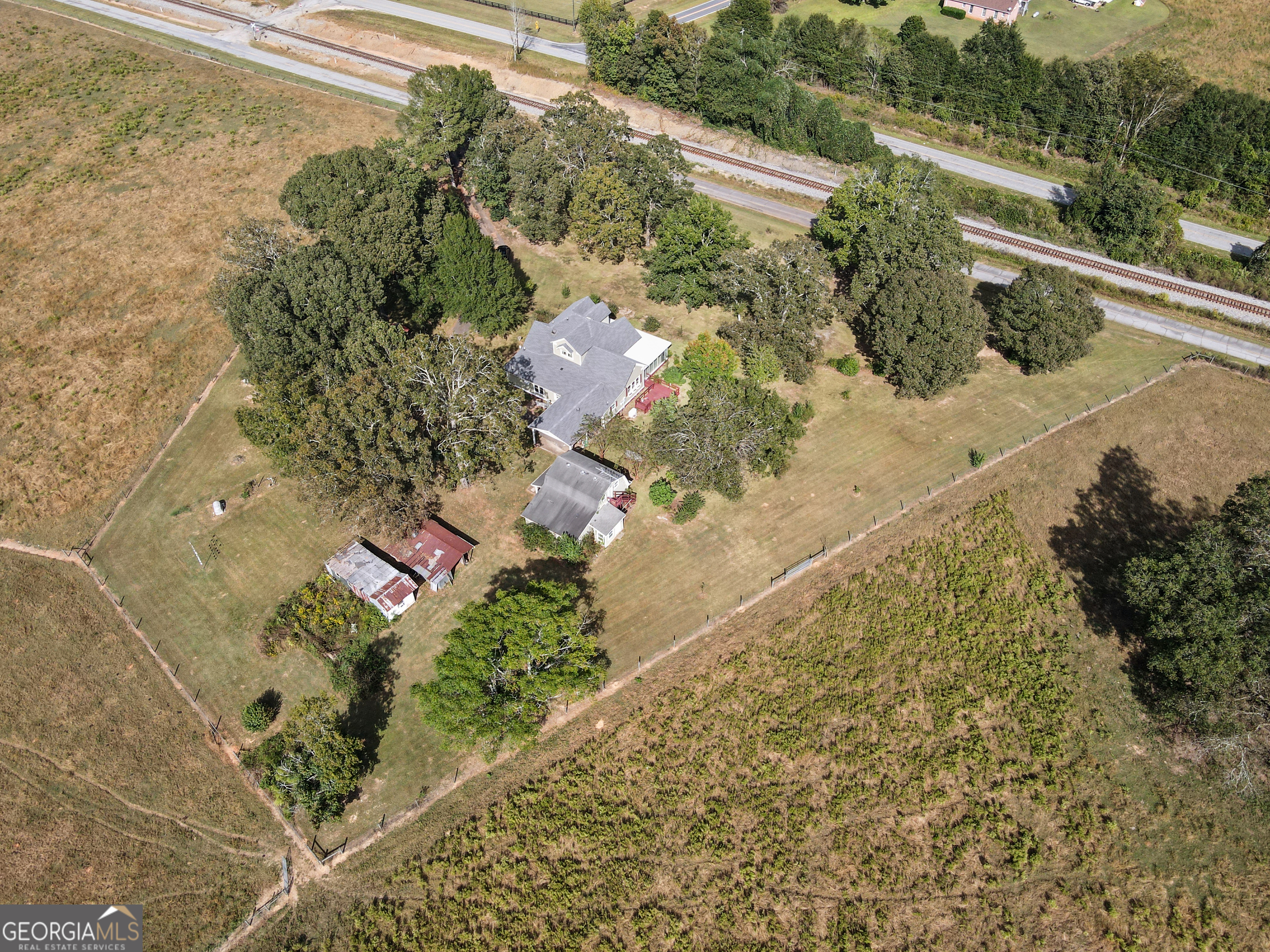 402 Tom Bell Road Milner, GA 30257 - Photo 61 of 64 a view of a yard with plants and wooden fence