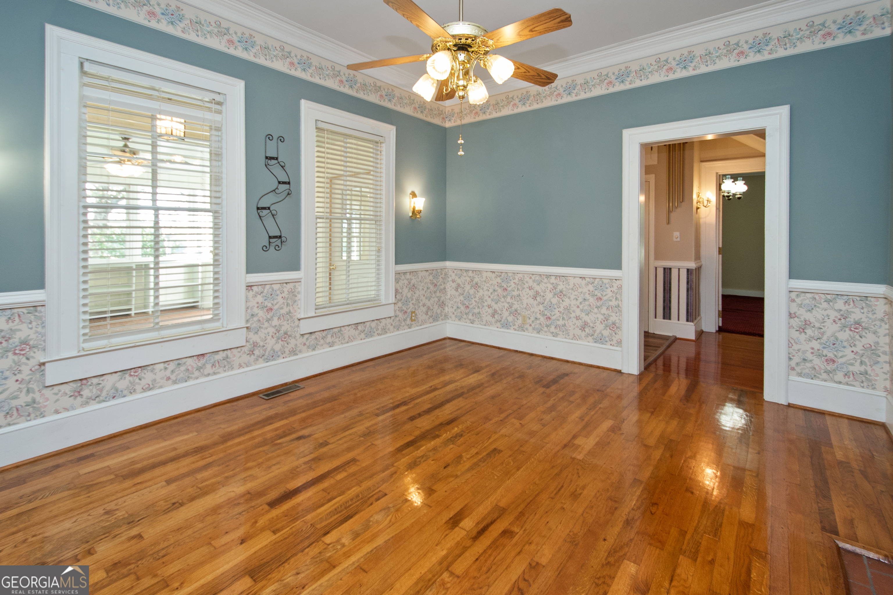 402 Tom Bell Road Milner, GA 30257 - Photo 9 of 64 a view of an empty room with wooden floor and a window