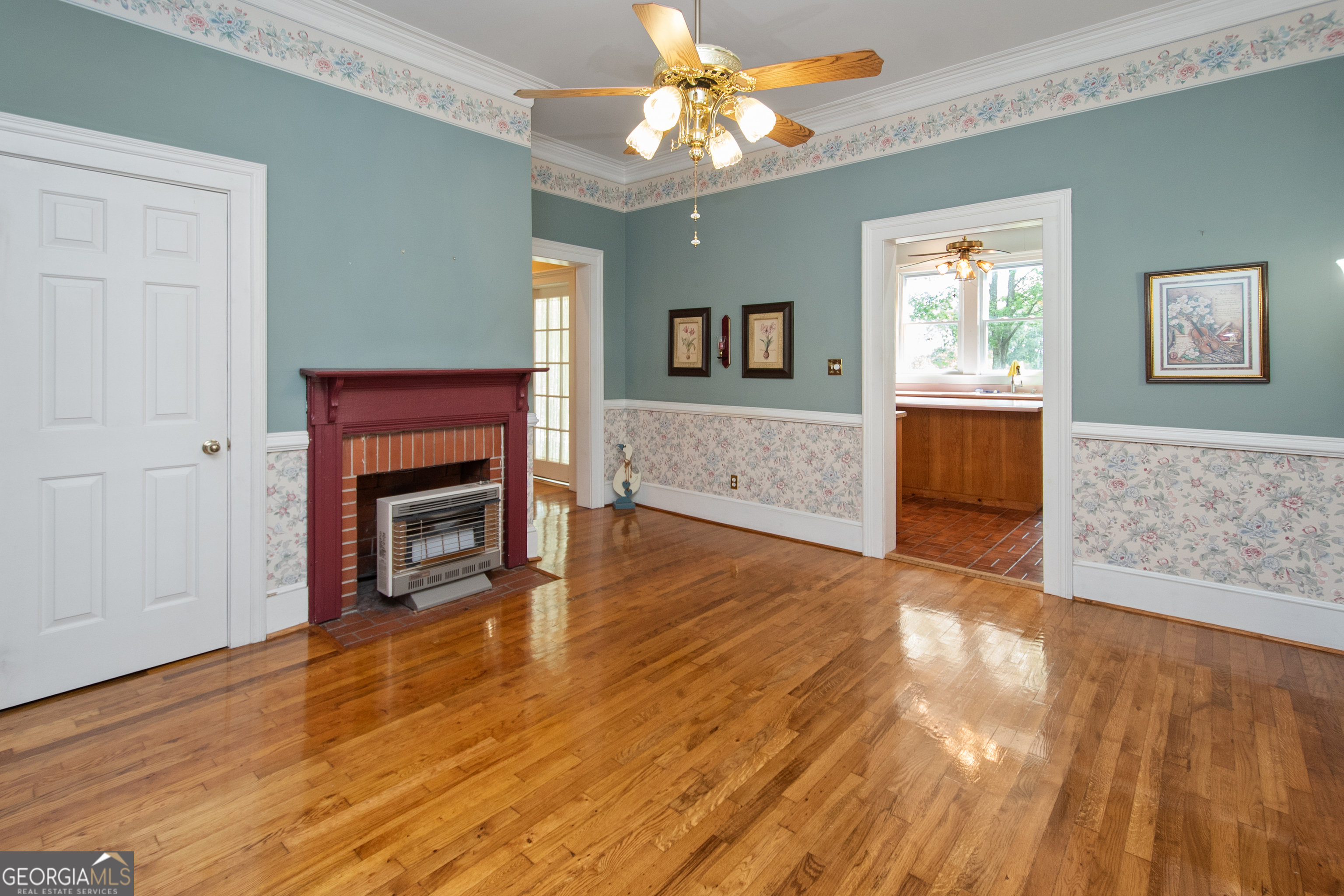 402 Tom Bell Road Milner, GA 30257 - Photo 10 of 64 a living room with fireplace furniture and a wooden floor