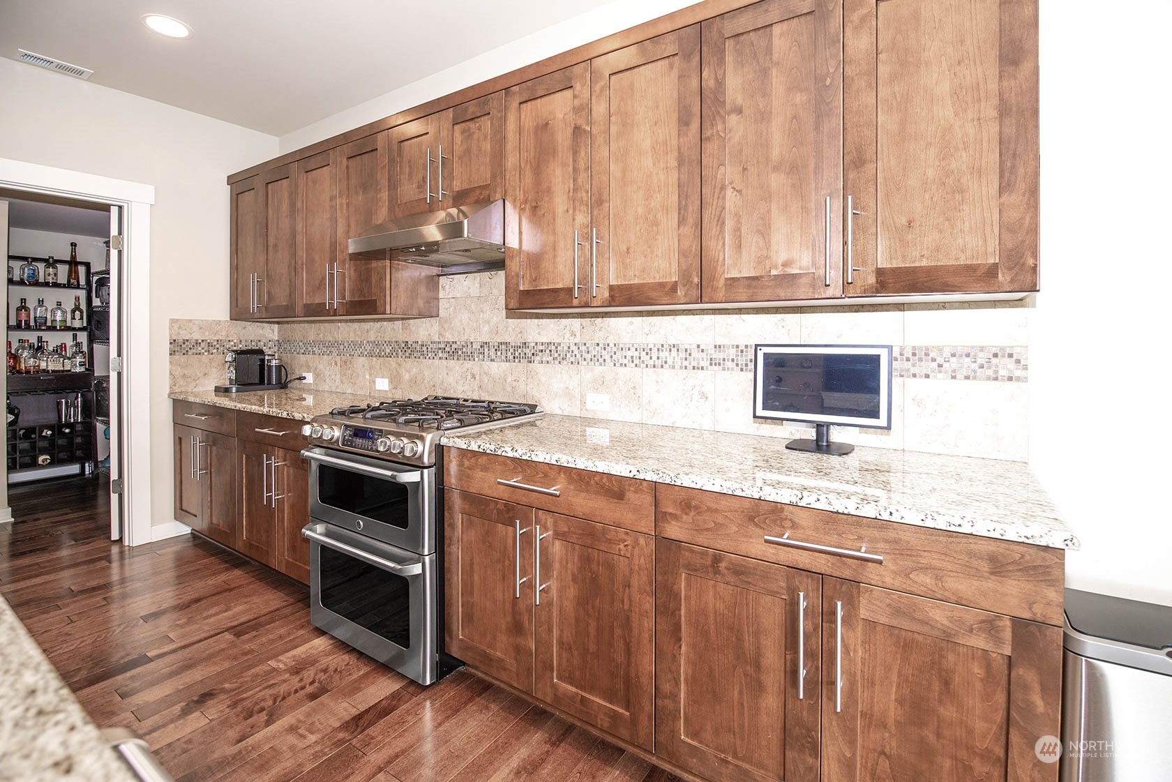 21127 35th Drive Southeast Bothell, WA 98021 - Photo 11 of 40 a kitchen with granite countertop wooden cabinets and stainless steel appliances