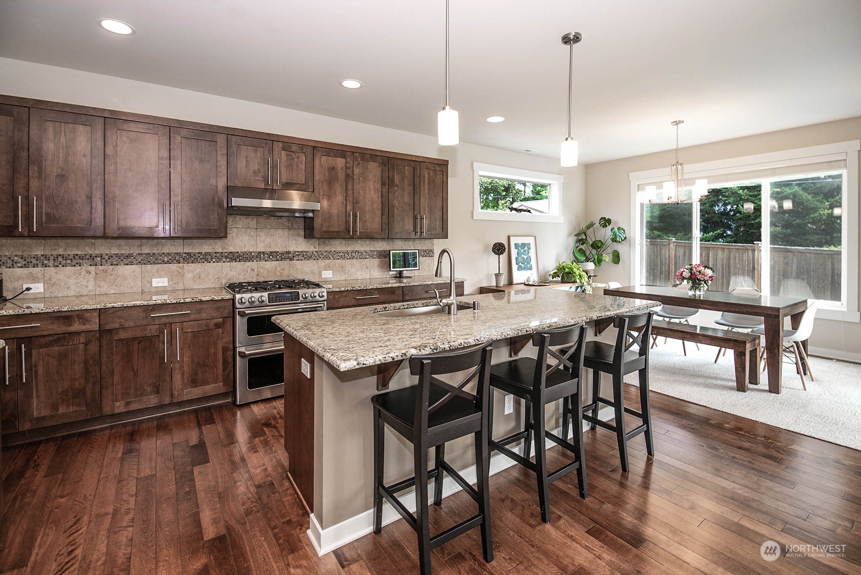 21127 35th Drive Southeast Bothell, WA 98021 - Photo 12 of 40 a kitchen with stainless steel appliances granite countertop wooden floors stove and white cabinets