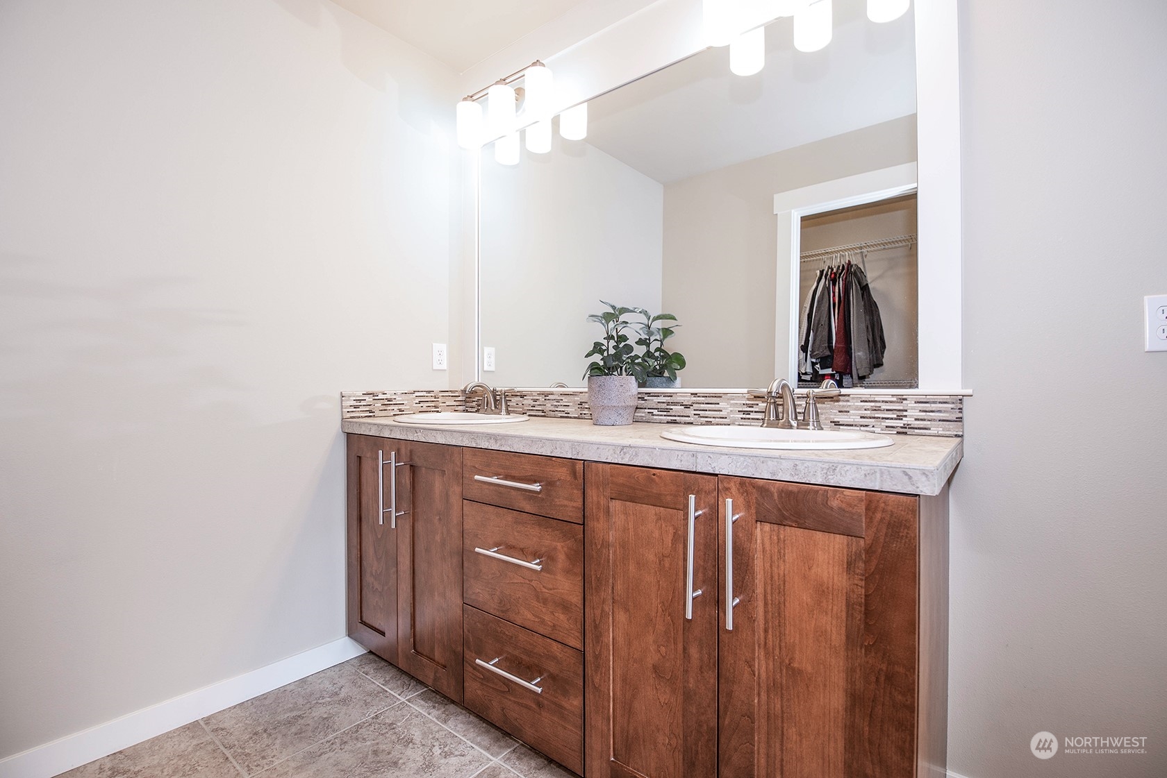 21127 35th Drive Southeast Bothell, WA 98021 - Photo 28 of 40 a bathroom with a granite countertop sink and a mirror
