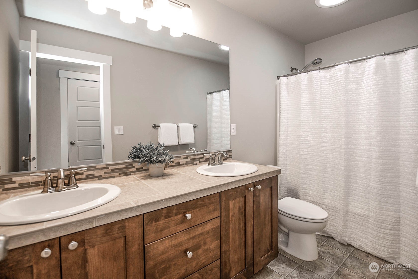 21127 35th Drive Southeast Bothell, WA 98021 - Photo 32 of 40 a bathroom with a double vanity sink toilet and a mirror