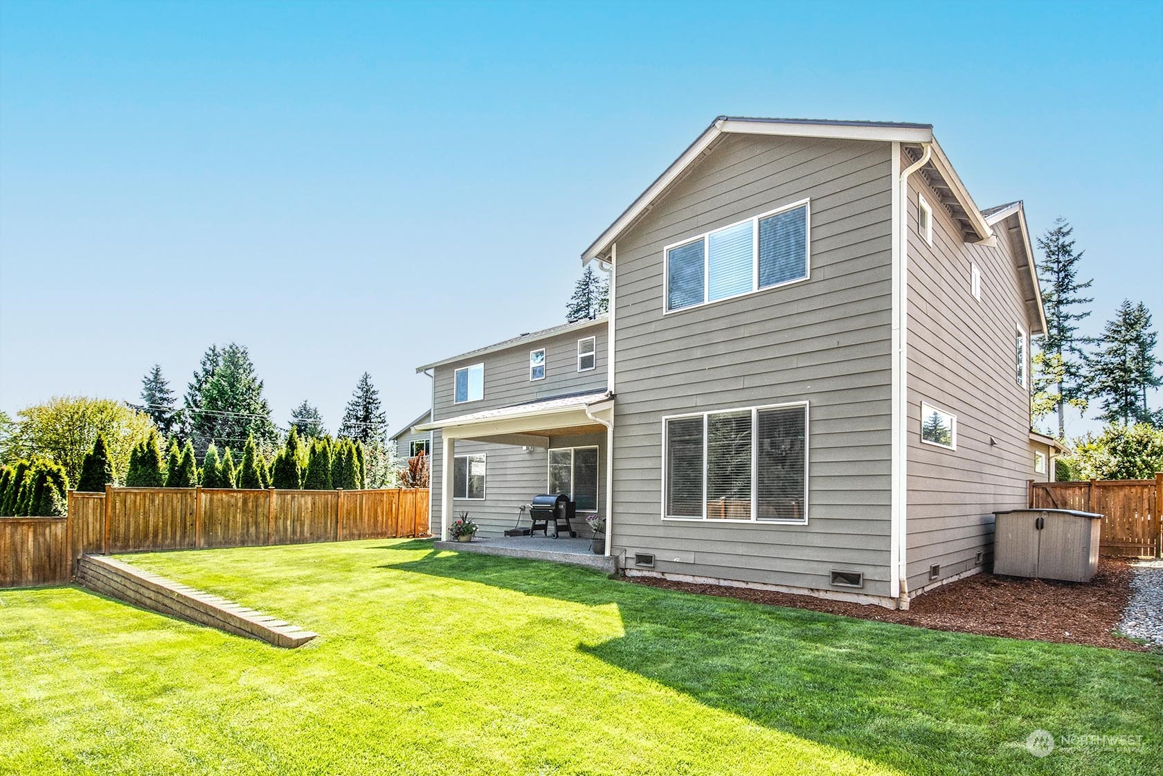 21127 35th Drive Southeast Bothell, WA 98021 - Photo 34 of 40 a backyard of a house with a garden and barbeque oven
